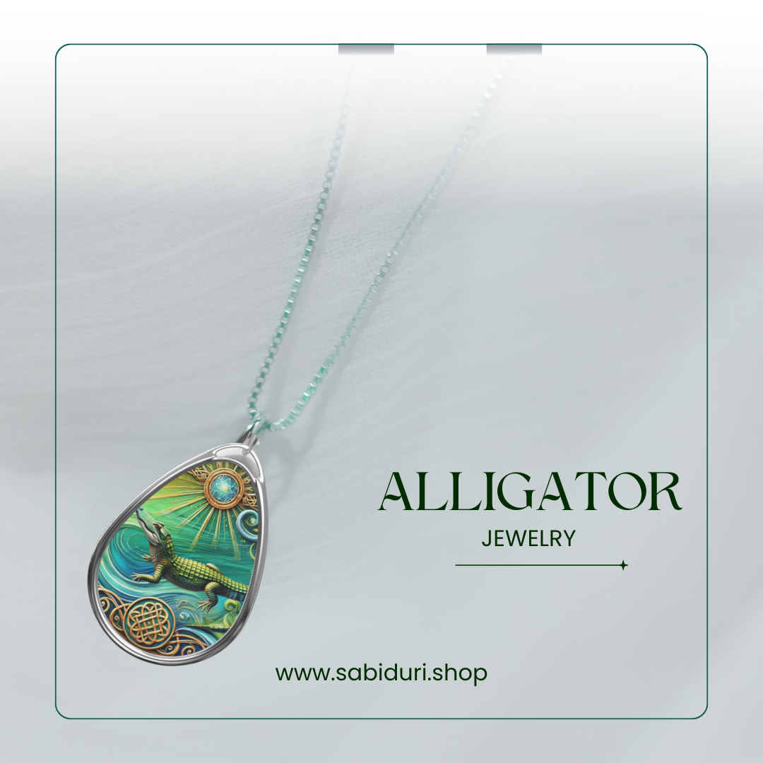 A silver alligator pendant necklace displayed on a soft white background. The pendant showcases an alligator gliding through stylized waters, surrounded by sunbursts and intricate patterns. The text reads "ALLIGATOR Jewelry" along with the website "www.sabiduri.shop.