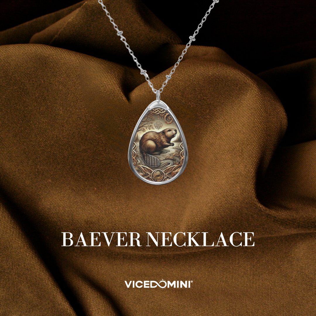 A teardrop-shaped silver pendant necklace featuring an intricate Koi fish illustration with gold, blue, and red details, displayed on draped brown satin fabric. The text 'KOI FISH NECKLACE' and the brand 'VICEDOMINI' are printed below.
