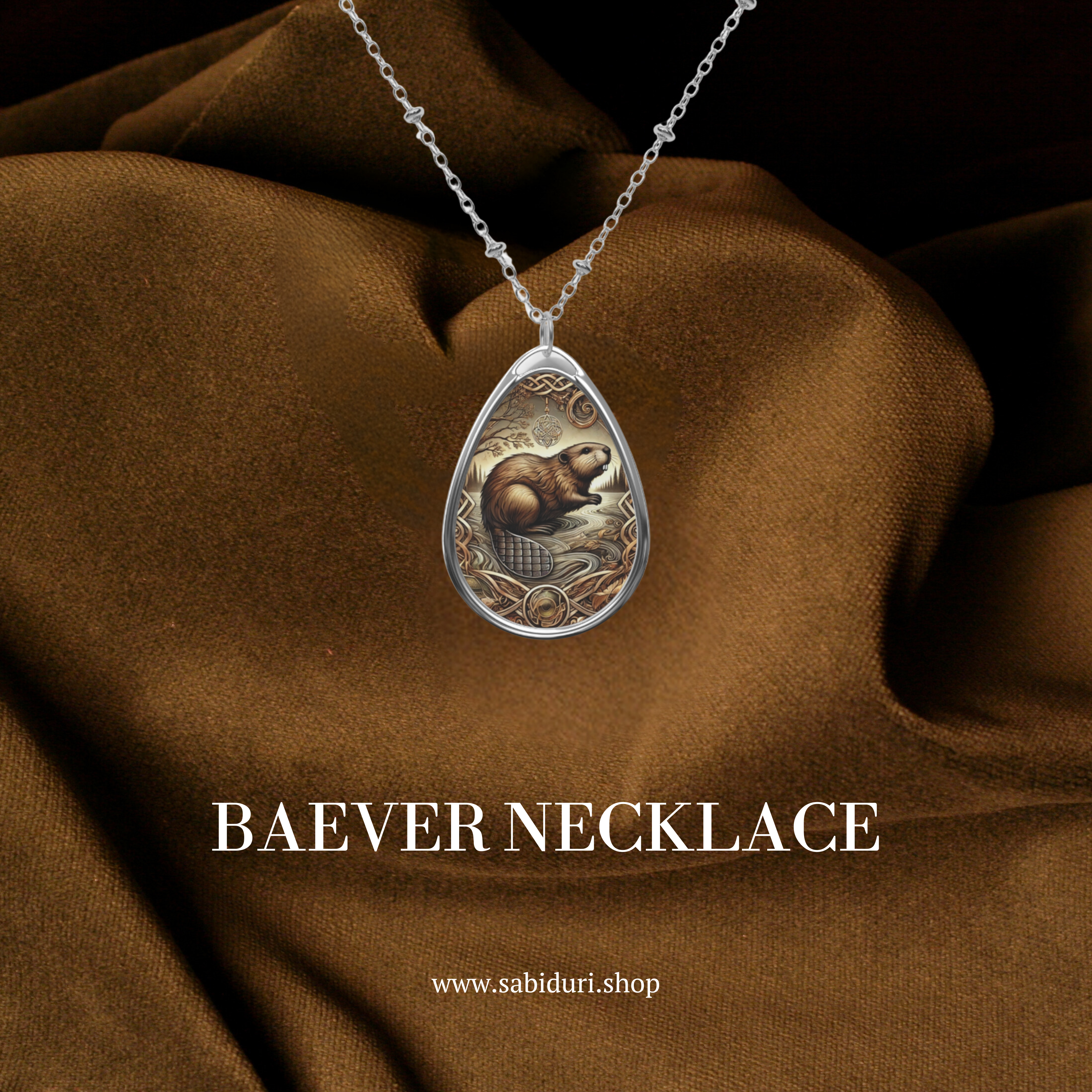 A close-up of the bobcat necklace against a luxurious brown fabric backdrop. The pendant showcases a detailed bobcat standing in a natural setting, framed with ornate golden accents. Below, the text "BOBCAT NECKLACE" and "www.sabiduri.shop" add branding.