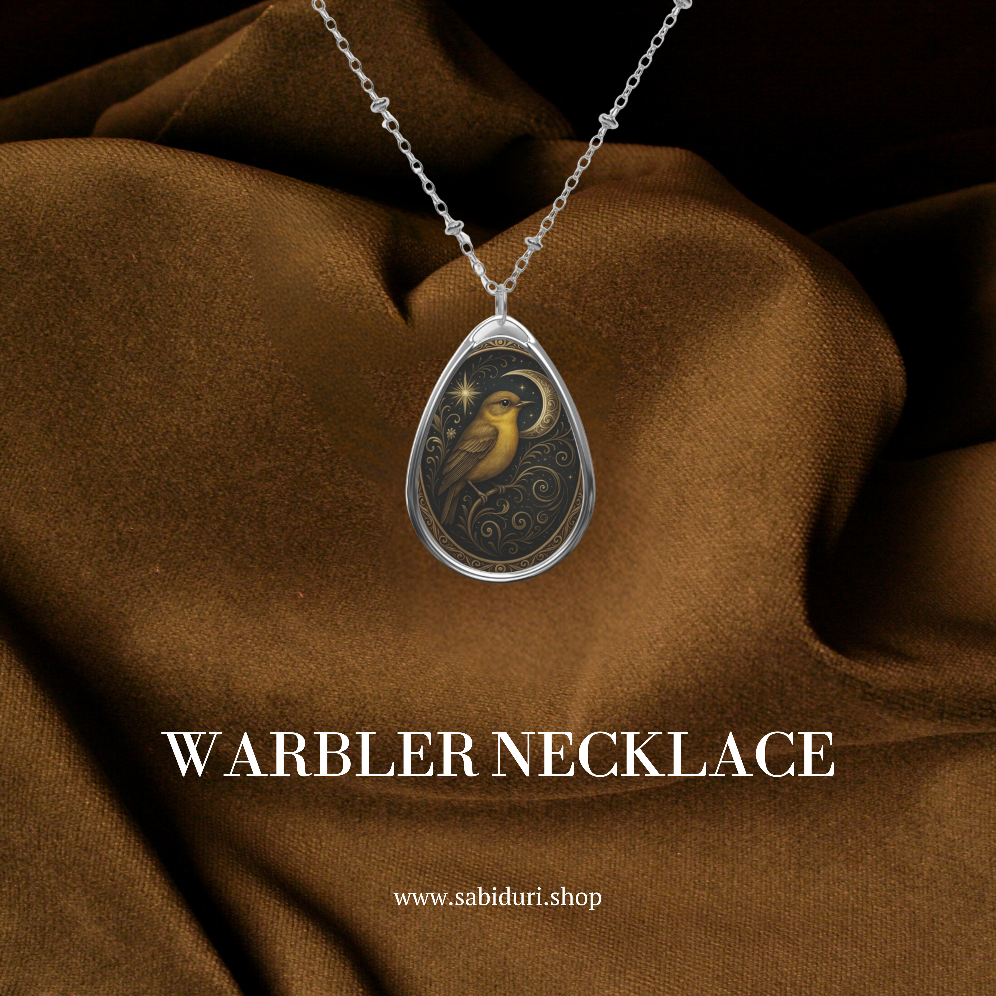 Warbler necklace resting on rich brown fabric, showcasing a golden bird with a crescent moon motif. The piece embodies the Warbler spiritual meaning and symbolic significance of inner voice, transition, and poetic beauty.