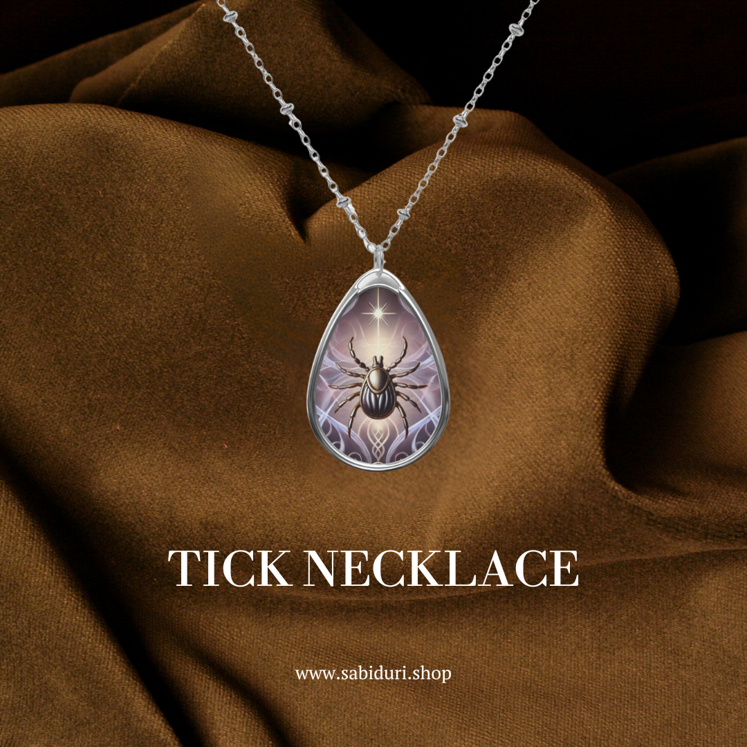 A tick necklace with a teardrop-shaped pendant featuring a detailed tick illustration under a star, elegantly displayed against a rich brown fabric background, accompanied by the text 'TICK NECKLACE' and the website 'www.sabiduri.shop'.