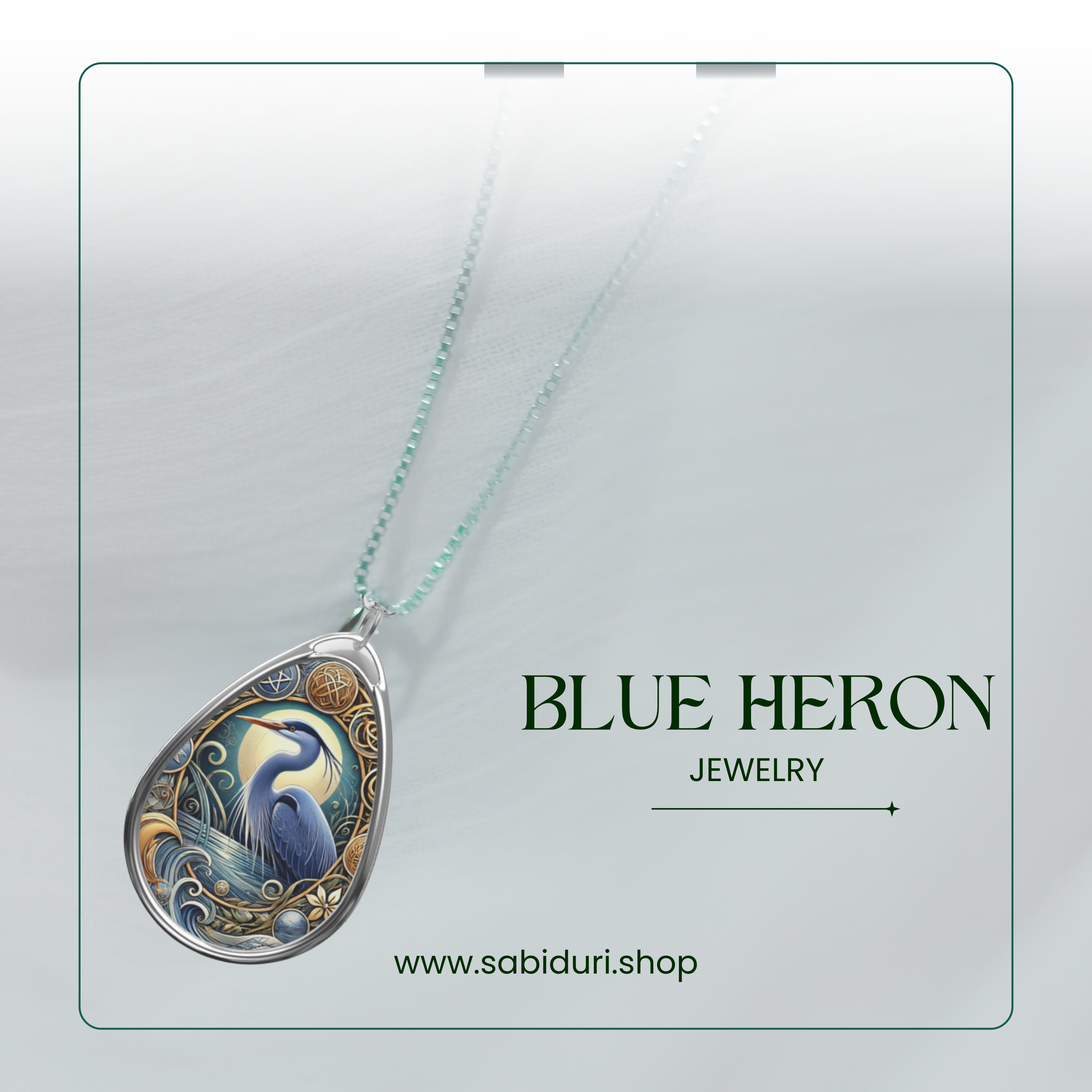 A silver necklace featuring a blue heron pendant displayed on a soft white background. The pendant captures a graceful blue heron surrounded by intricate wave and plant motifs, symbolizing tranquility and self-reliance. The text reads "BLUE HERON Jewelry" along with the website "www.sabiduri.shop.