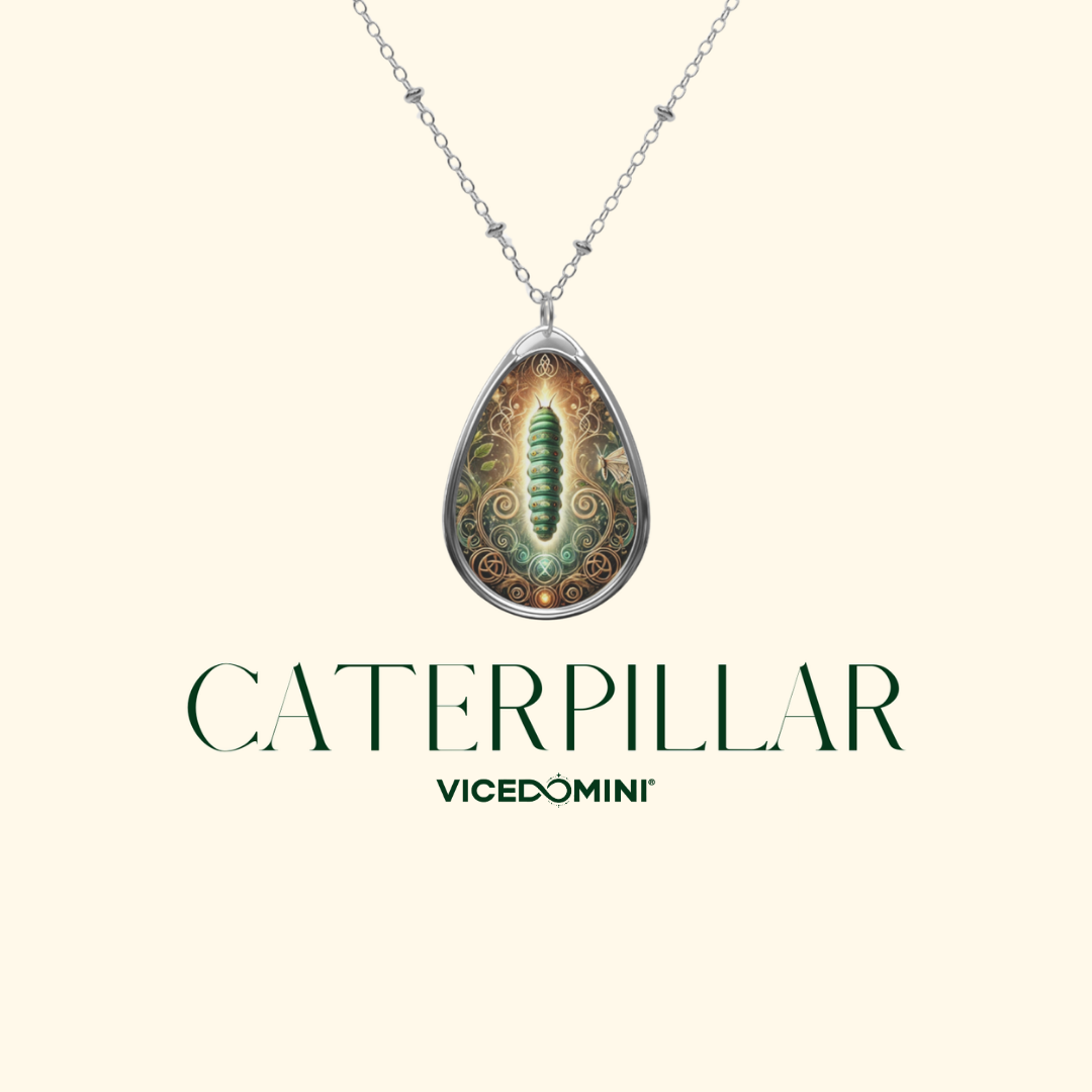 A silver teardrop pendant necklace featuring a detailed illustration of a green caterpillar on a beige and brown background, displayed on a cream background with the text 'CATERPILLAR VICEDOMINI' below.