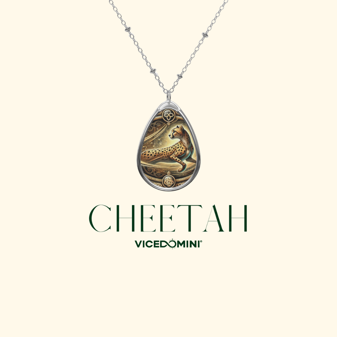 A silver teardrop pendant necklace featuring an engraved cheetah design, displayed on a light cream background with the brand name 'VICEDOMINI' and the word 'CHEETAH' printed below.