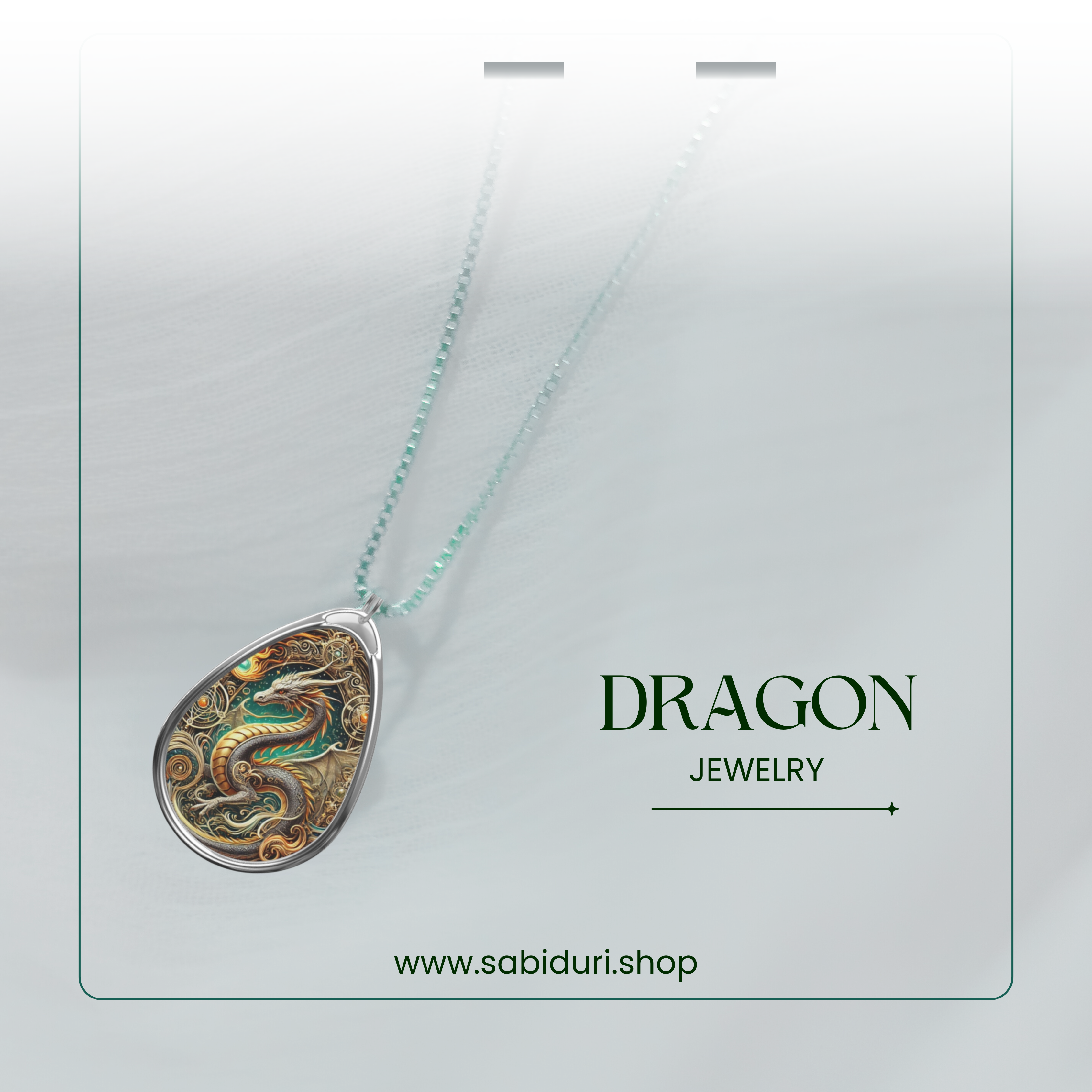 A mystical Dragon necklace on a delicate silver chain, featuring a detailed dragon motif with golden and green swirls. The blurred white background gives the image an ethereal feel, with the text "DRAGON JEWELRY" and the website "www.sabiduri.shop" adding a refined branding touch.