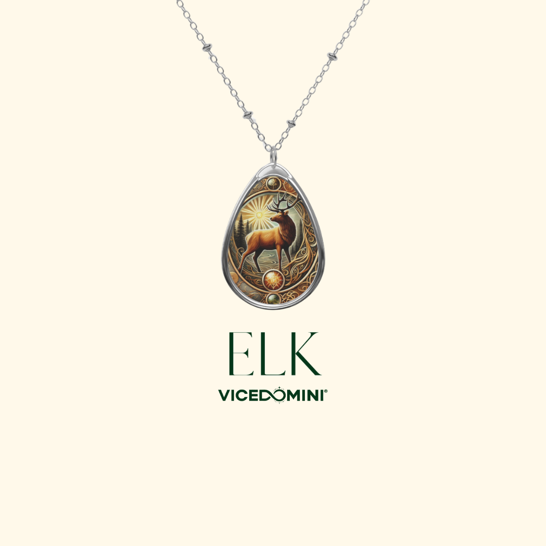 A silver teardrop pendant necklace featuring an engraved elk design with warm gold and brown tones, shown on a light cream background with the brand name 'ELK VICEDOMINI' below.