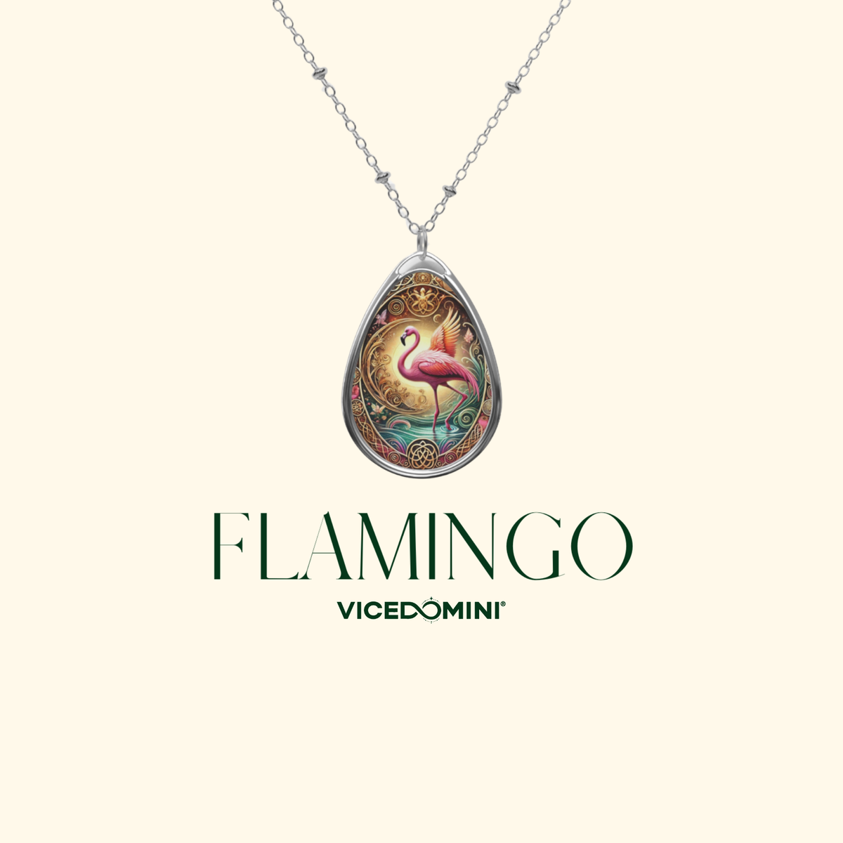 A silver teardrop pendant necklace featuring a colorful illustration of a pink flamingo, displayed on a cream background with the text 'FLAMINGO VICEDOMINI'.