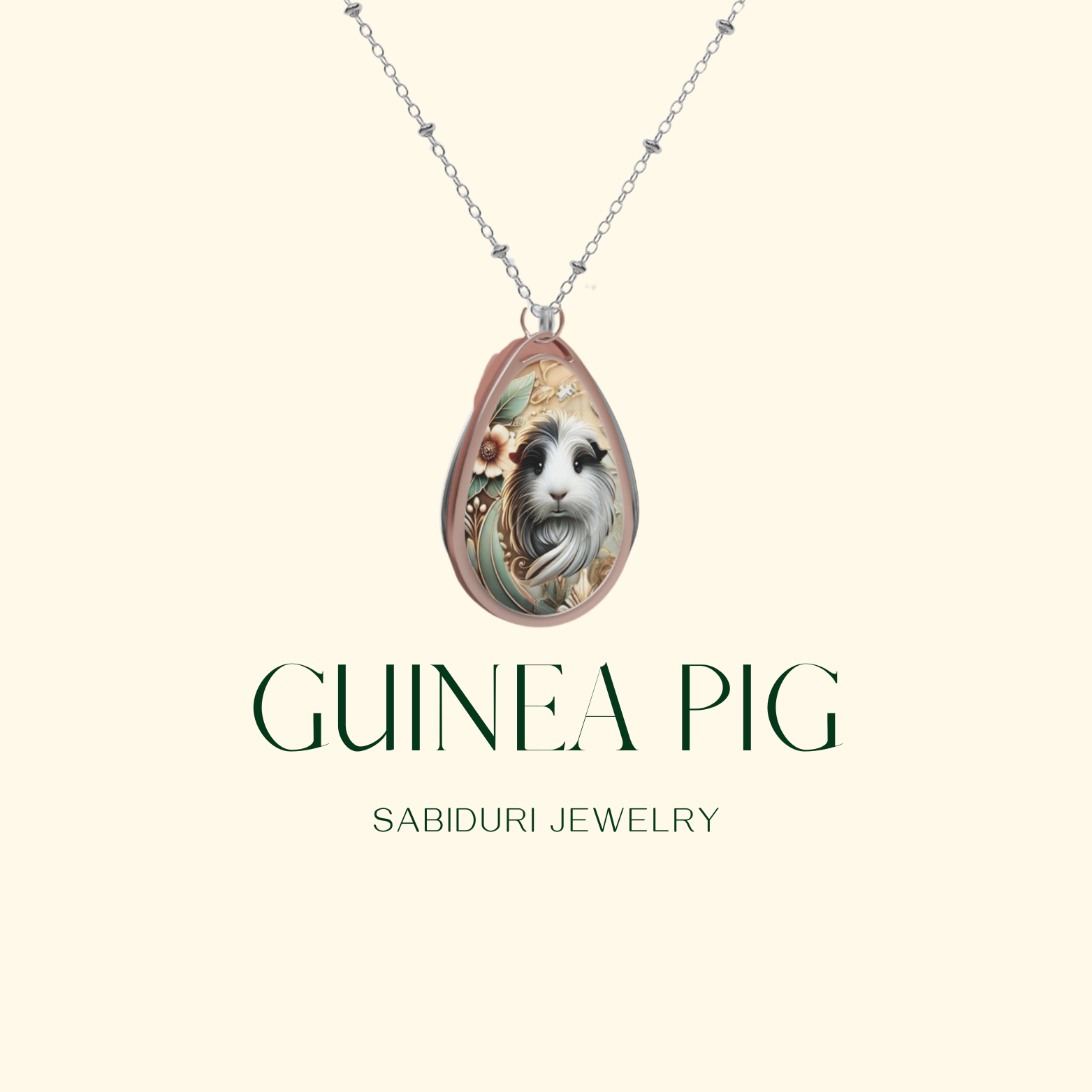 A close-up of a teardrop-shaped pendant featuring a detailed and charming illustration of a guinea pig surrounded by floral elements in soft colors. The necklace is displayed on a simple light background with the text "GUINEA PIG" and "SABIDURI JEWELRY" in green beneath it.