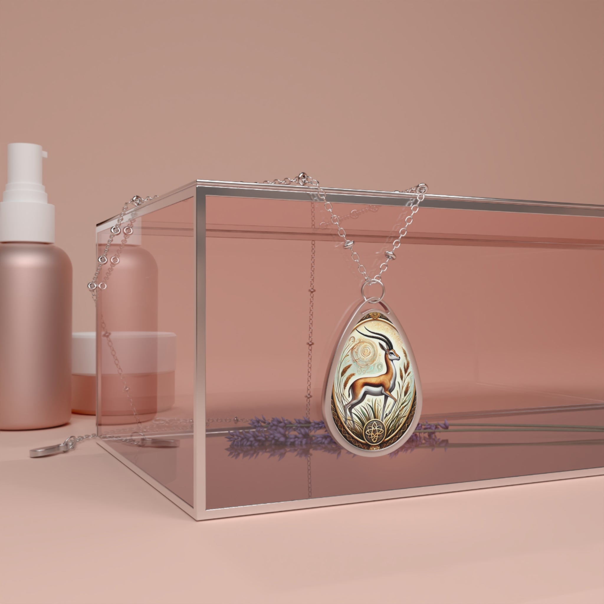 A lifestyle shot of the Gazelle spirit animal necklace draped over a transparent display box with a warm beige background. The pendant, featuring a finely detailed gazelle surrounded by ornate patterns, hangs from a delicate silver chain. Lavender sprigs are placed beneath the box for a natural aesthetic.