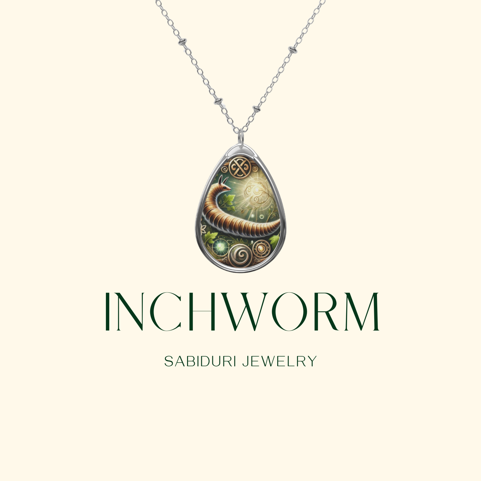 A close-up of the Inchworm spirit animal necklace by Sabiduri Jewelry, featuring a detailed inchworm design within a teardrop pendant. The pendant is adorned with swirling gold accents and glowing green highlights, hanging from a fine silver chain. "INCHWORM" and "SABIDURI JEWELRY" text is elegantly placed beneath the pendant.