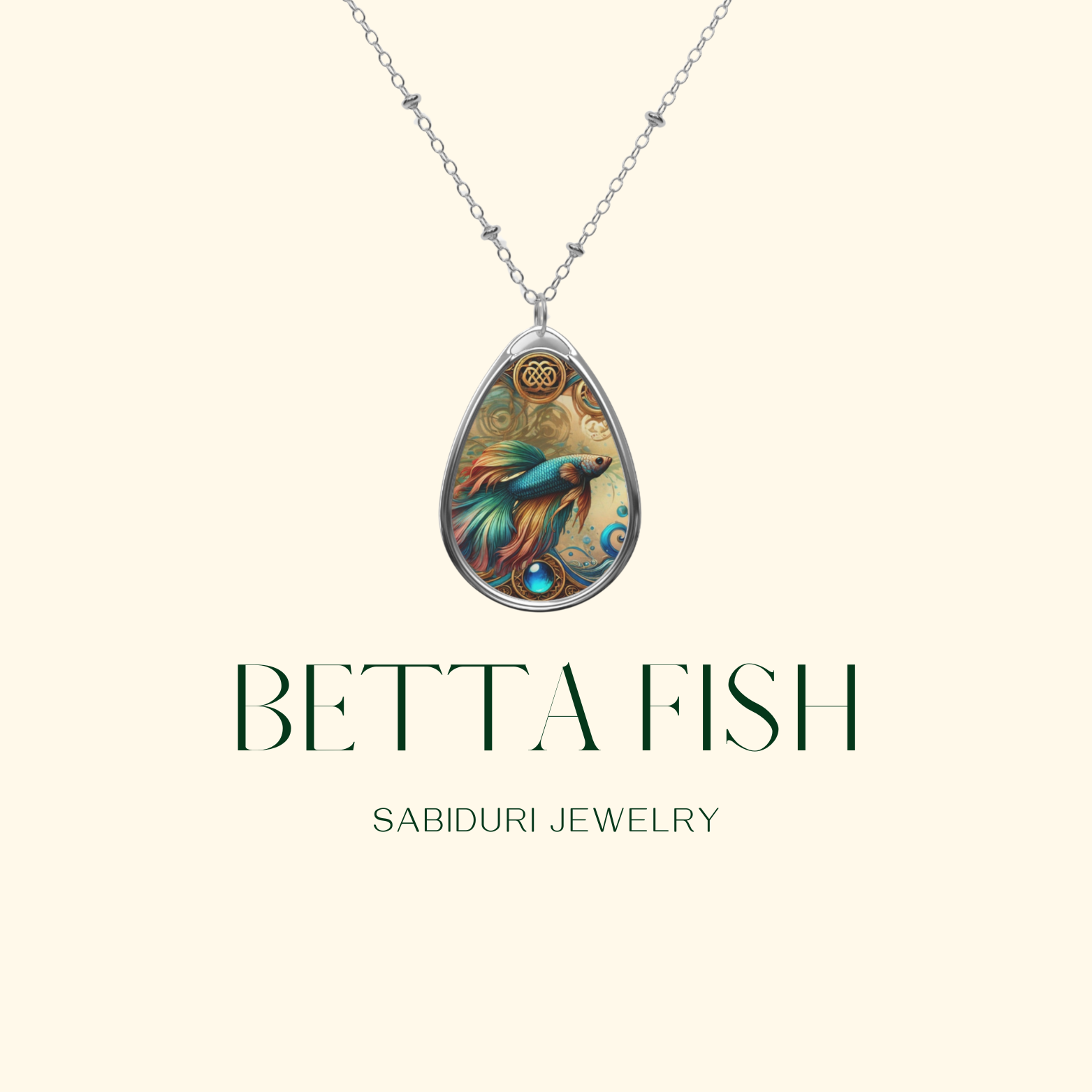 A minimalist presentation of the Betta Fish necklace against a neutral cream background. The teardrop pendant features the detailed fish artwork, swirling accents, and gemstone detail, accompanied by the text "Betta Fish – Sabiduri Jewelry."