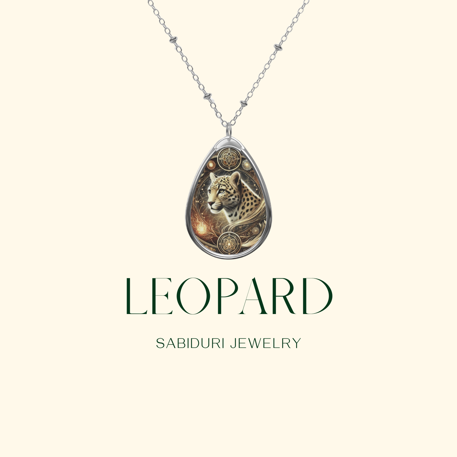 A stunning leopard pendant necklace with a silver teardrop-shaped frame, suspended from a delicate silver chain. The background is a soft cream color, featuring the text "LEOPARD" in elegant typography, followed by "SABIDURI JEWELRY."