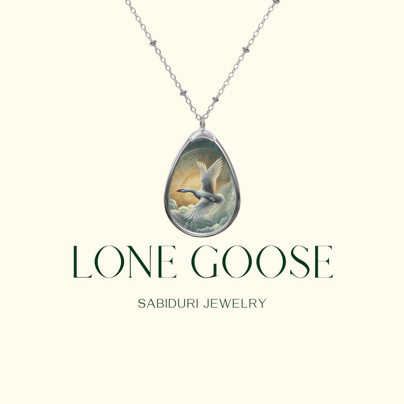 A silver teardrop-shaped pendant featuring a detailed artwork of a flying goose against a bright sun, shown on a simple, cream-colored background. The text "Lone Goose Sabiduri Jewelry" is prominently displayed, branding the jewelry piece.