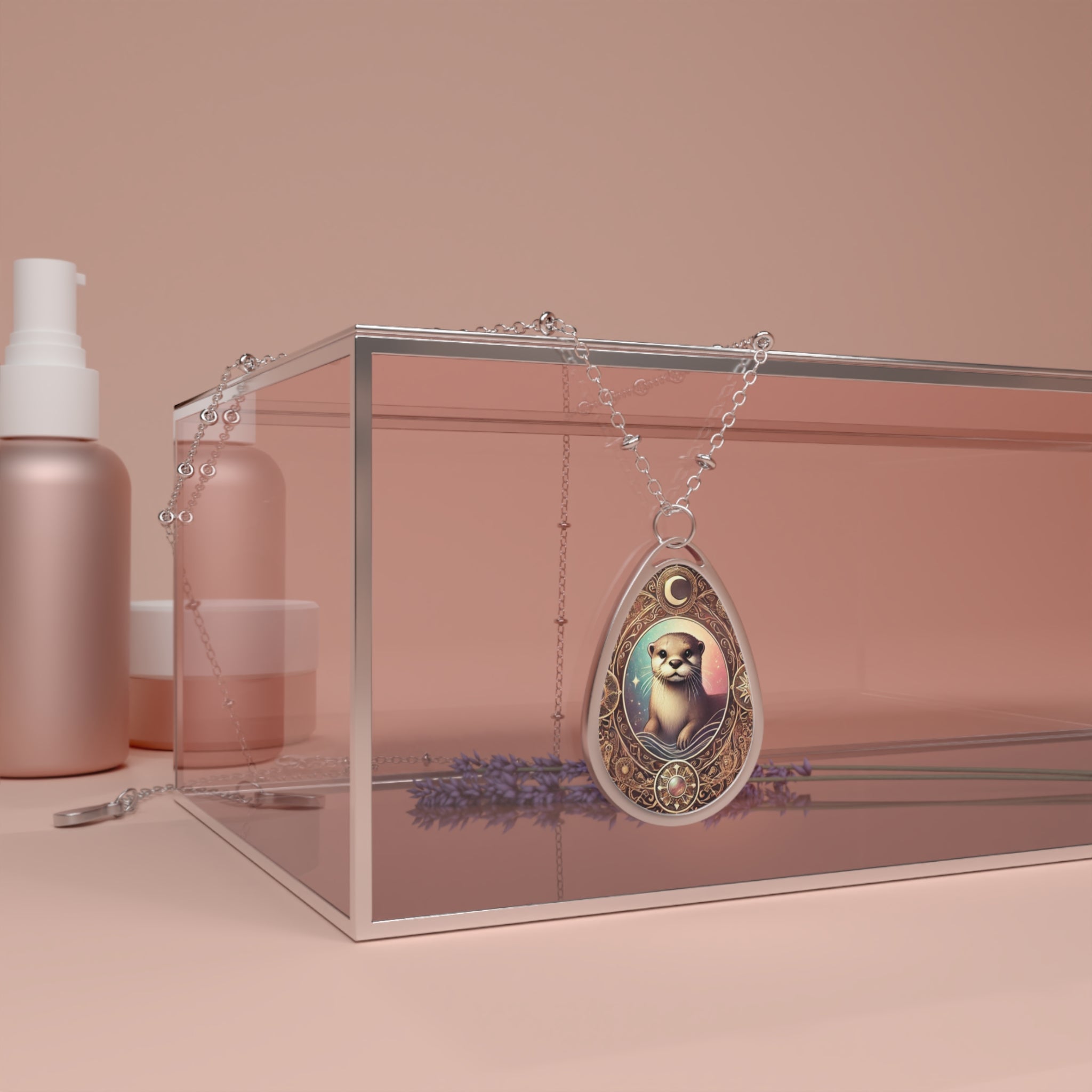 The Otter pendant necklace draped over a sleek, transparent display box on a minimalist vanity setting. The pendant's filigree and celestial-inspired design elements stand out, with a delicate silver chain elegantly arranged. The soft, neutral-toned background enhances the luxurious feel.
