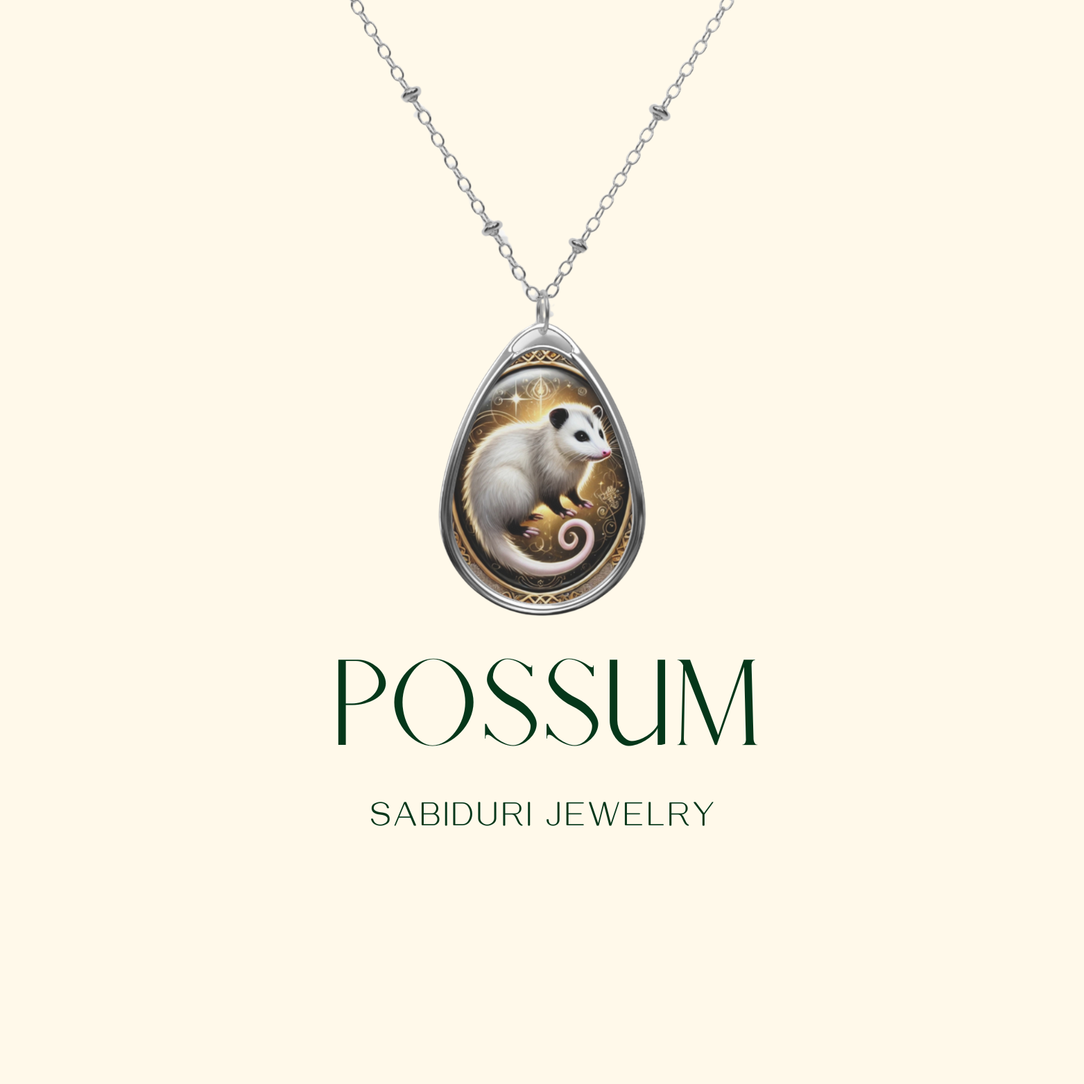 A teardrop-shaped silver pendant featuring an intricately designed possum illustration with soft white fur and a curled tail. The background inside the pendant has golden accents and delicate filigree details. Below the pendant, the text "POSSUM" and "SABIDURI JEWELRY" is elegantly displayed.