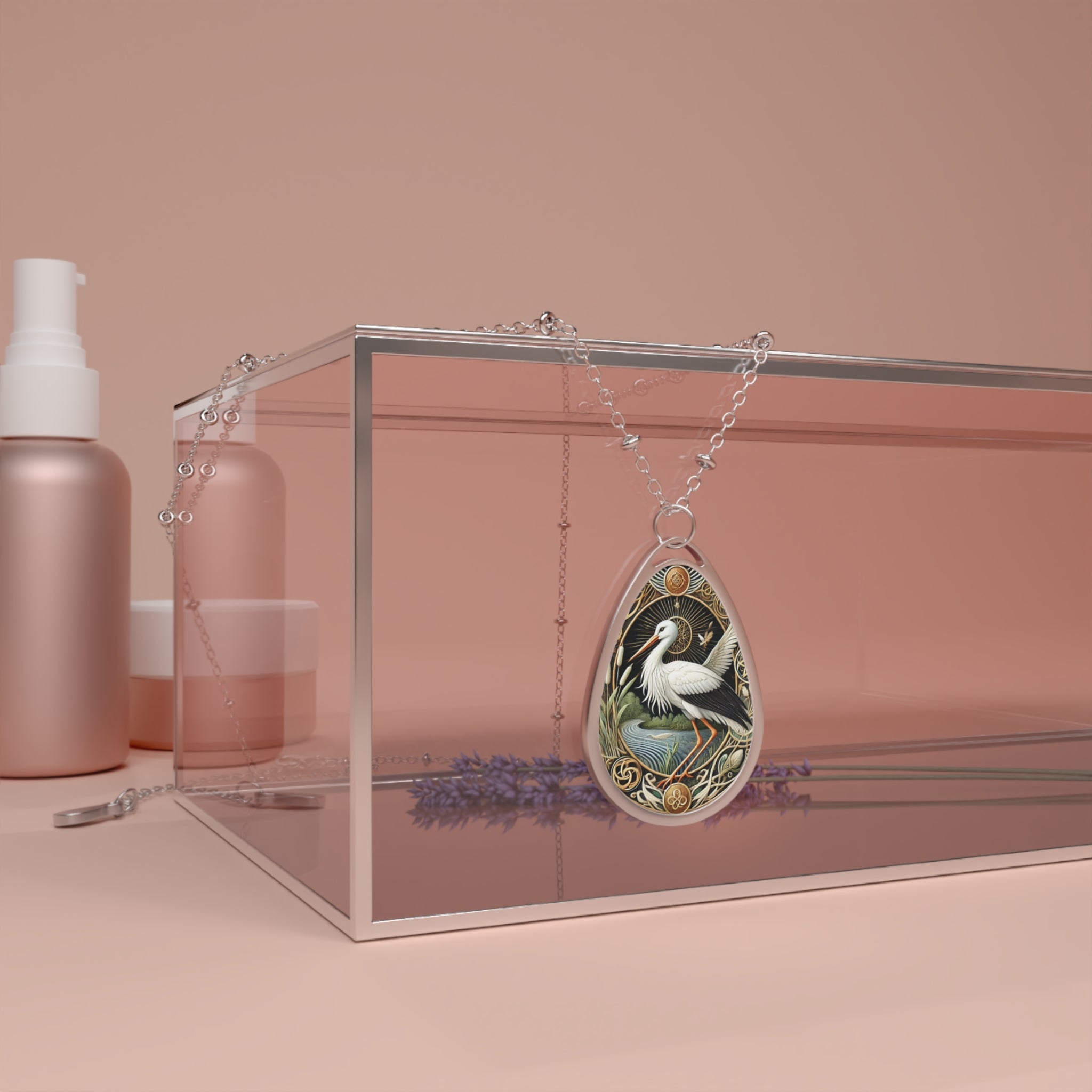 A stork spirit animal necklace displayed on a pink background, draped elegantly over a transparent glass box surrounded by lavender sprigs and skincare bottles.