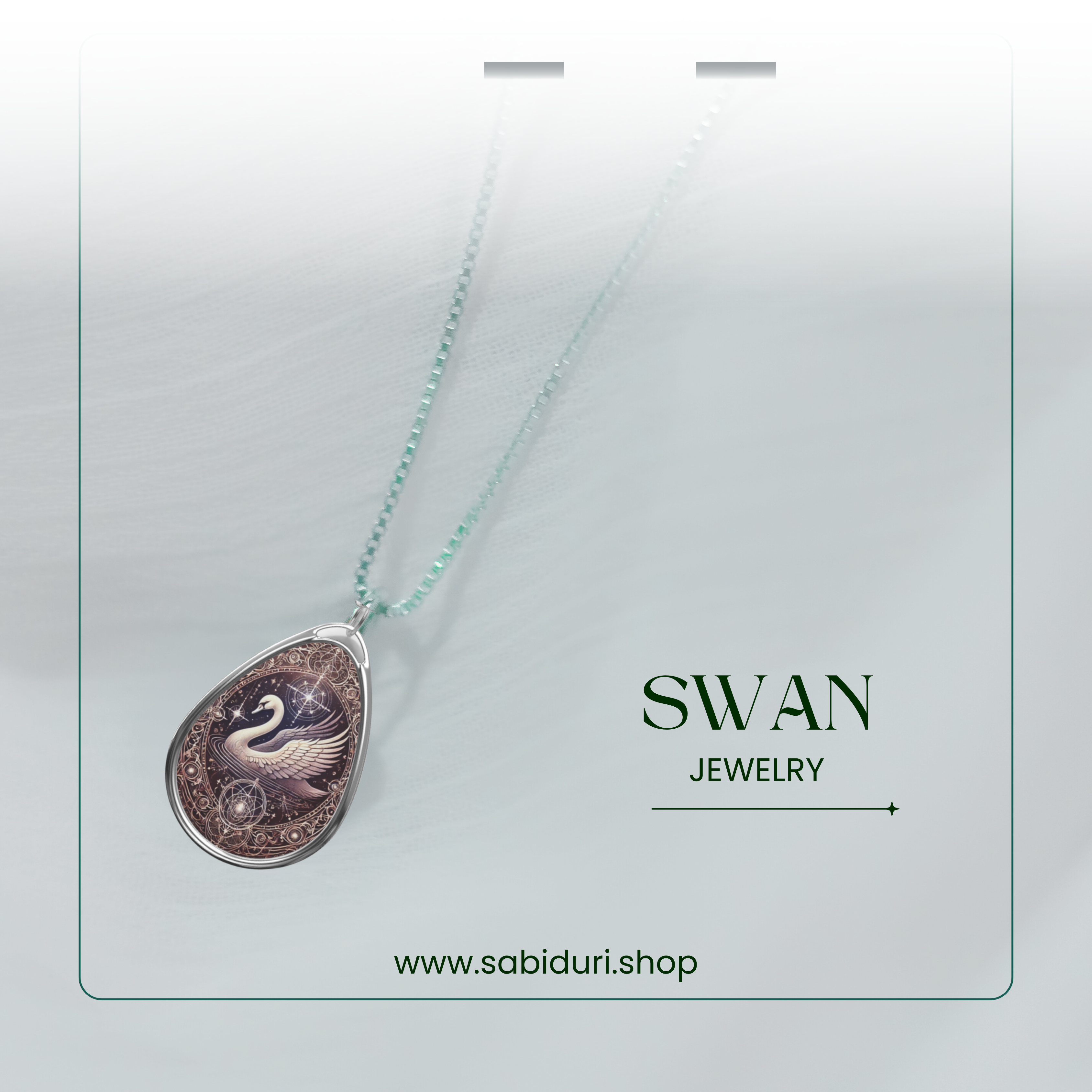 A close-up of the swan pendant necklace, suspended on a light-colored background with a subtle green gradient. The pendant features a celestial swan design with intricate gold and star details. The text "SWAN JEWELRY" and "www.sabiduri.shop" is placed stylishly in the layout.