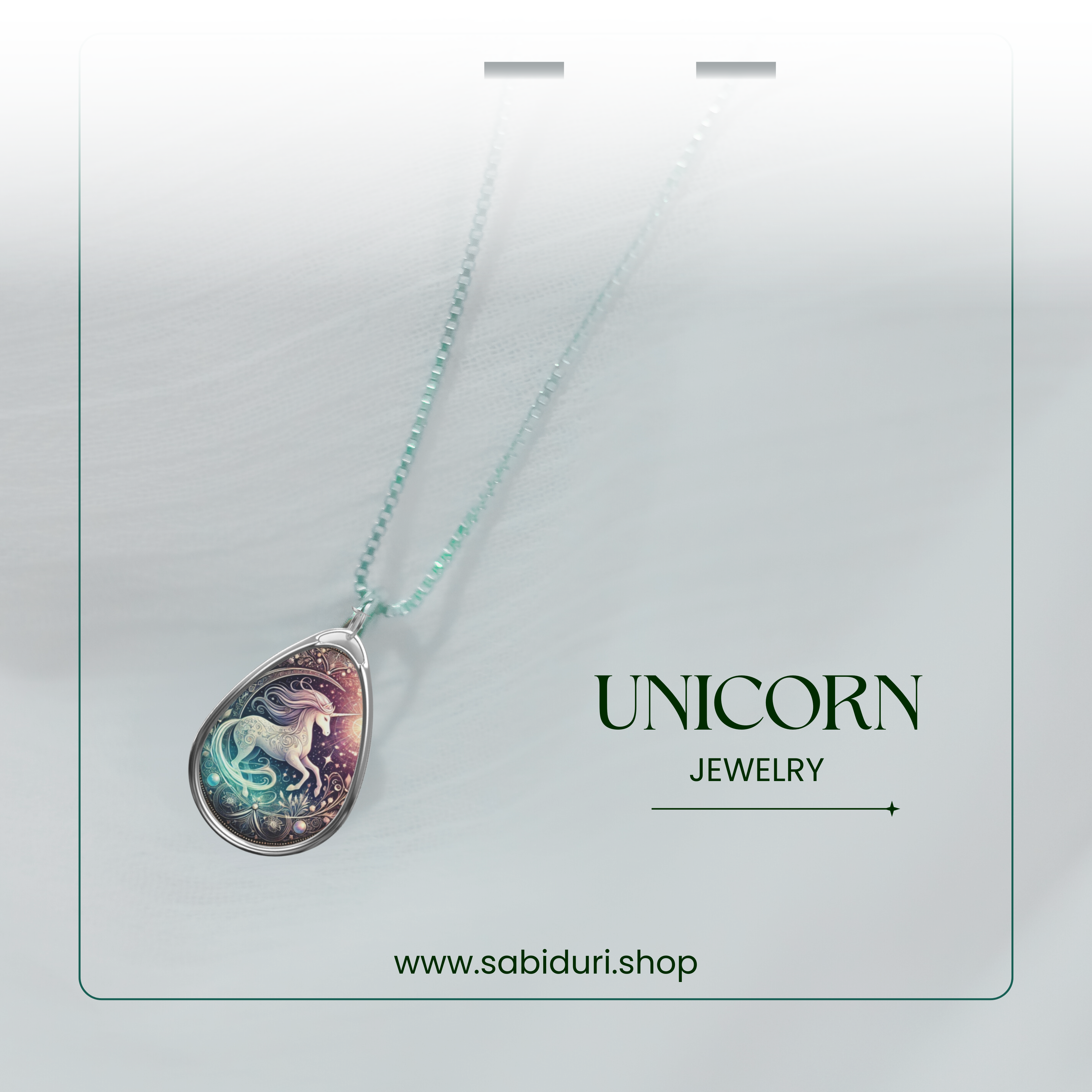 A close-up of the unicorn pendant hanging from a delicate chain, showcased against a soft, white background with a transparent card overlay. The words "UNICORN JEWELRY" and "www.sabiduri.shop" are elegantly positioned.