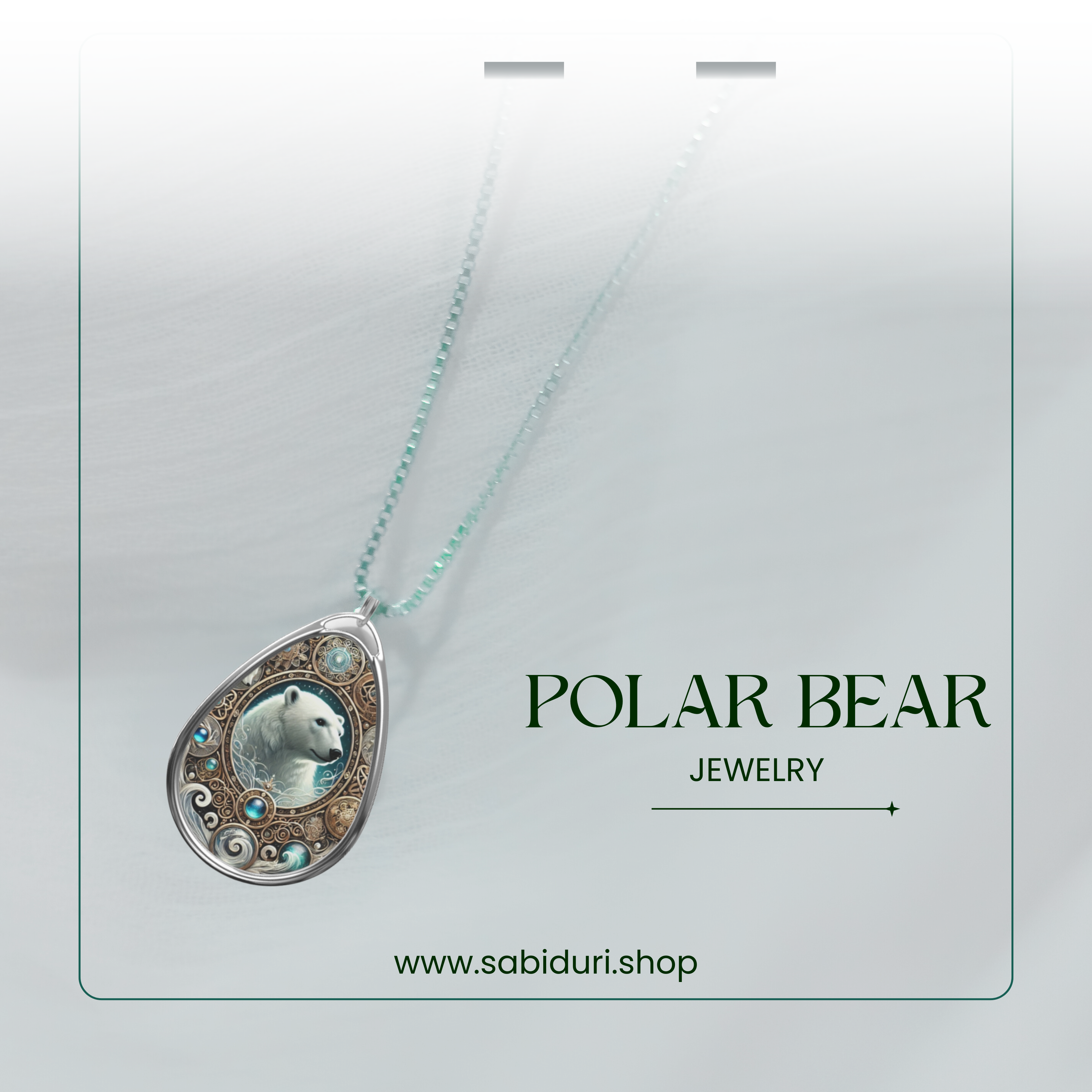 A softly lit image of the Polar Bear Jewelry pendant displayed on a white fabric surface. The pendant's blue and gold hues contrast against the background, with "Polar Bear Jewelry" and "www.sabiduri.shop" elegantly displayed.