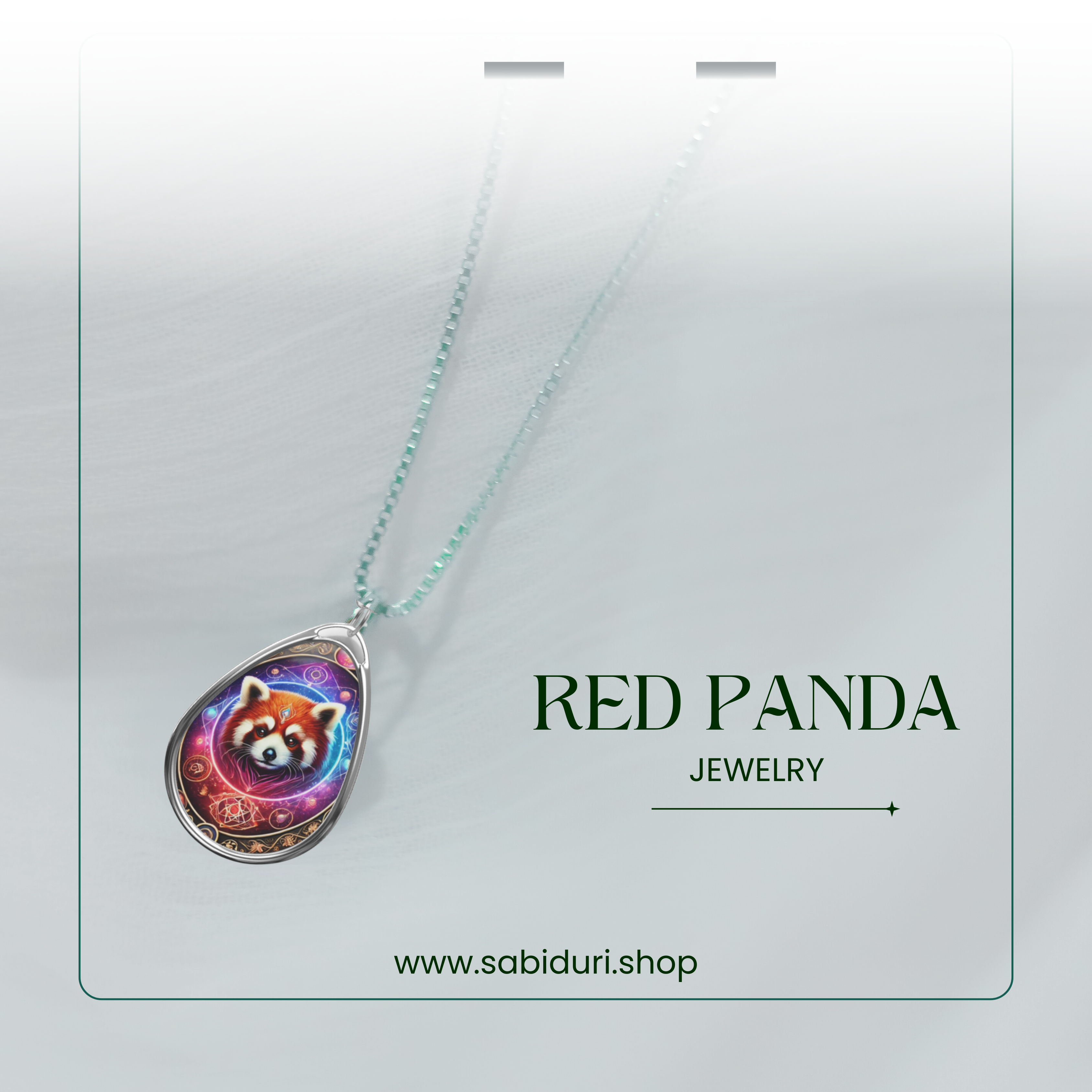 A delicate red panda pendant necklace with a cosmic-inspired design, suspended from a fine silver chain against a soft white fabric background. The words "RED PANDA JEWELRY" and "www.sabiduri.shop" are displayed in a clean, modern font.