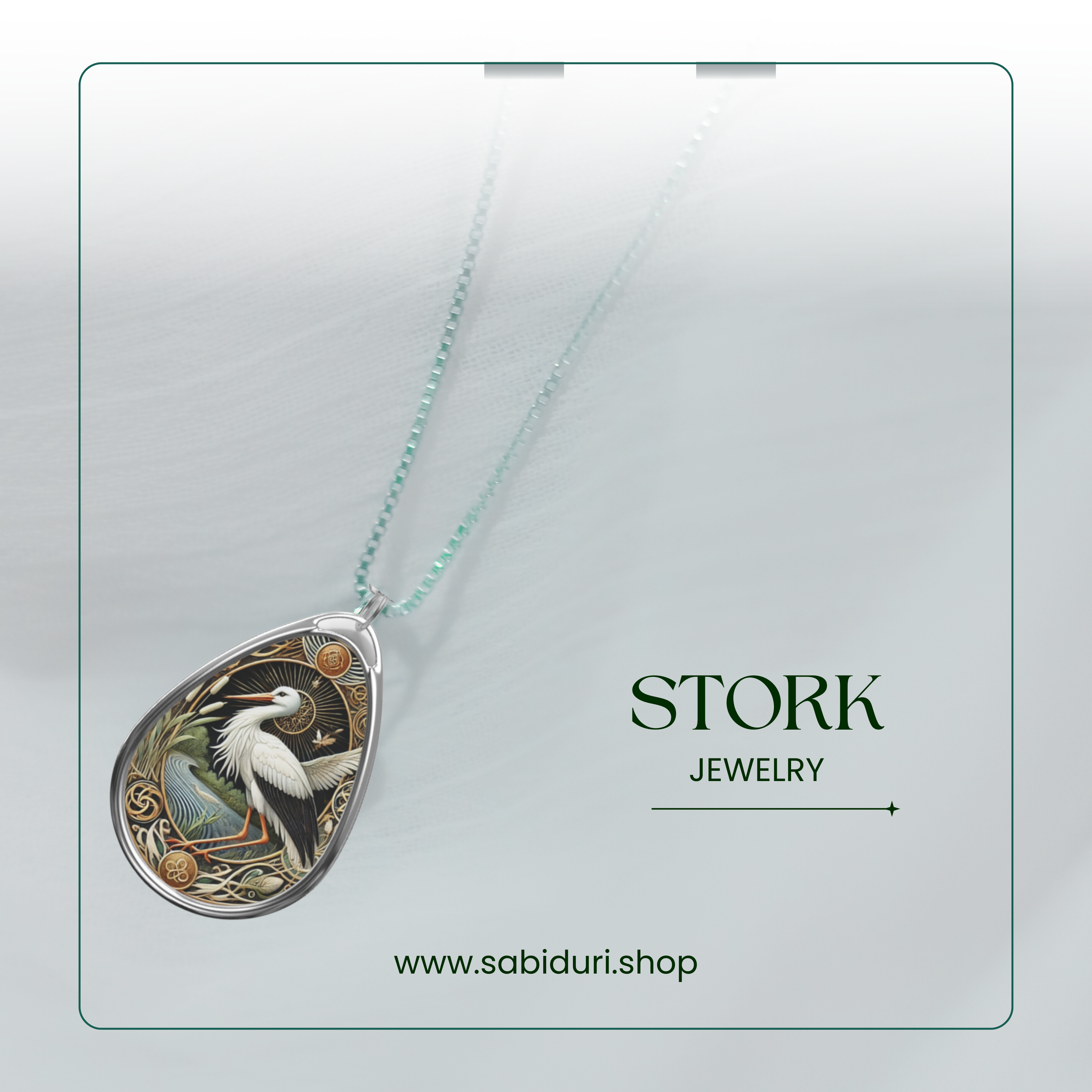 A close-up view of the stork spirit animal necklace against a soft white background with the text "Stork Jewelry" and a website URL (www.sabiduri.shop).