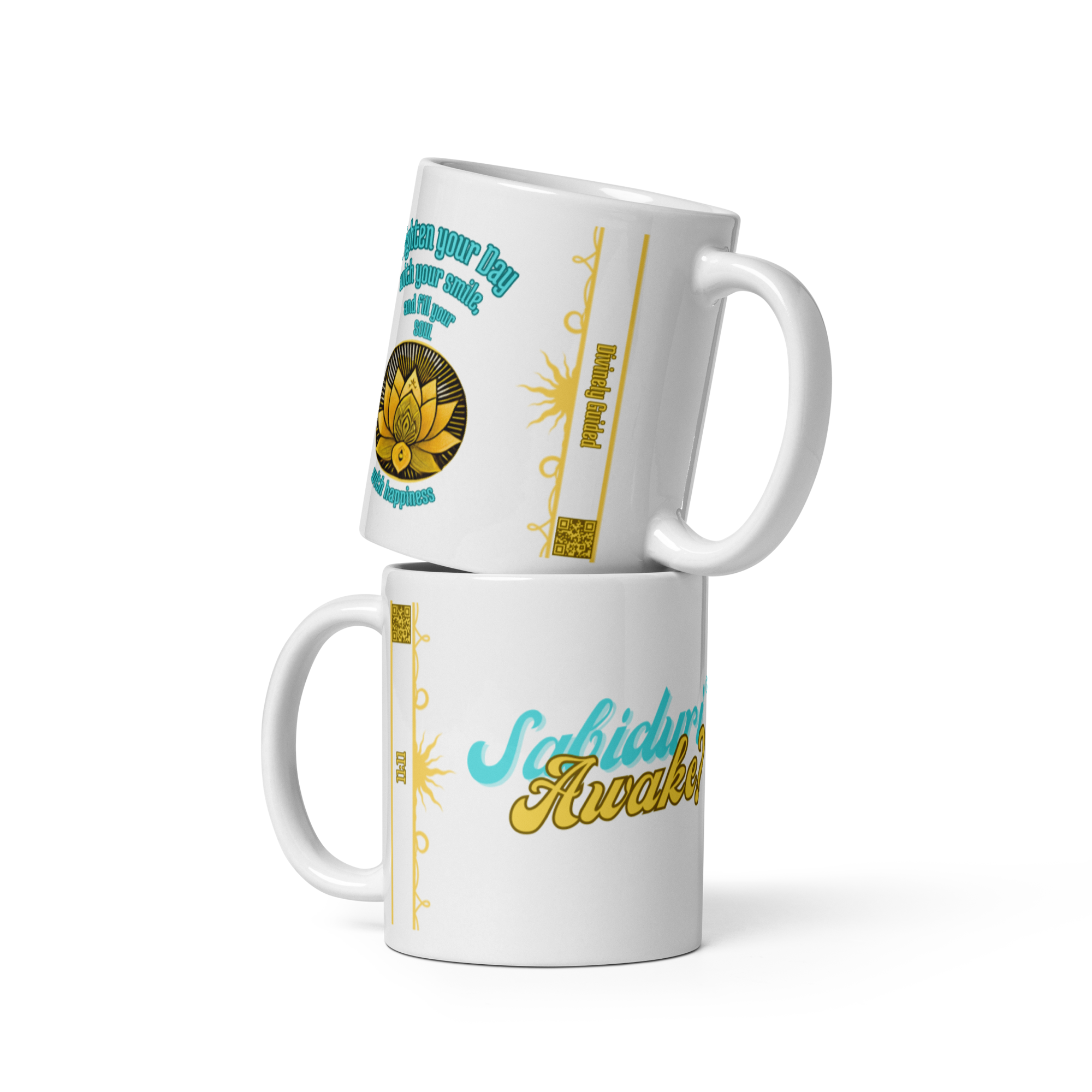 Two stacked white mugs with designs. The top mug shows the phrase "Brighten your Day with your smile, and fill your soul with happiness" with a lotus symbol. The bottom mug displays "Sabiduría Awake?" in a colorful and bold font.