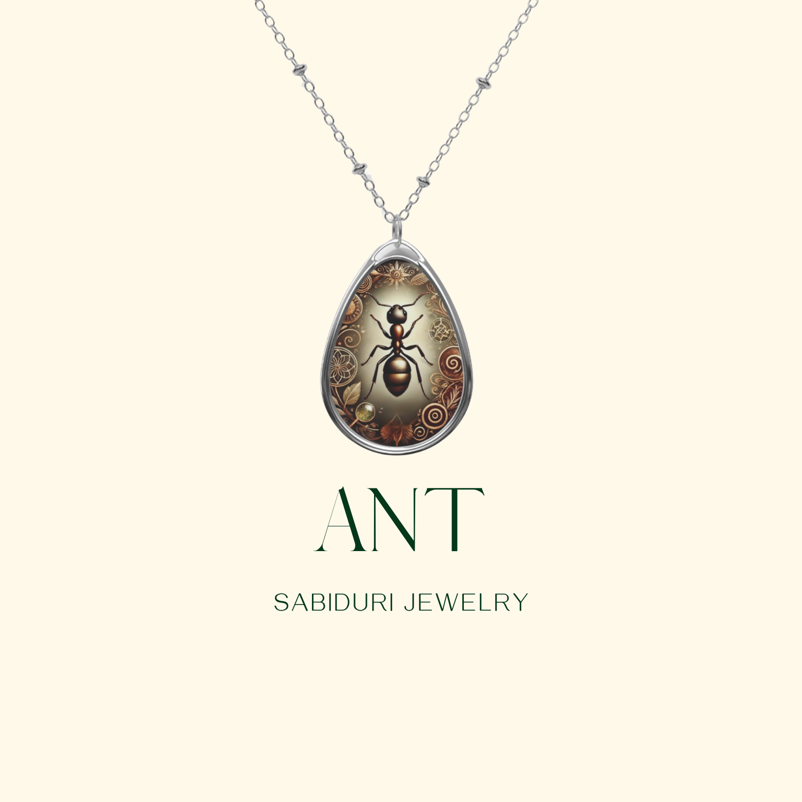 A delicate silver necklace with a teardrop-shaped pendant showcasing an ant surrounded by intricate nature-inspired engravings. The pendant is displayed on a neutral background, with the text "ANT" and "SABIDURI JEWELRY" elegantly positioned beneath.