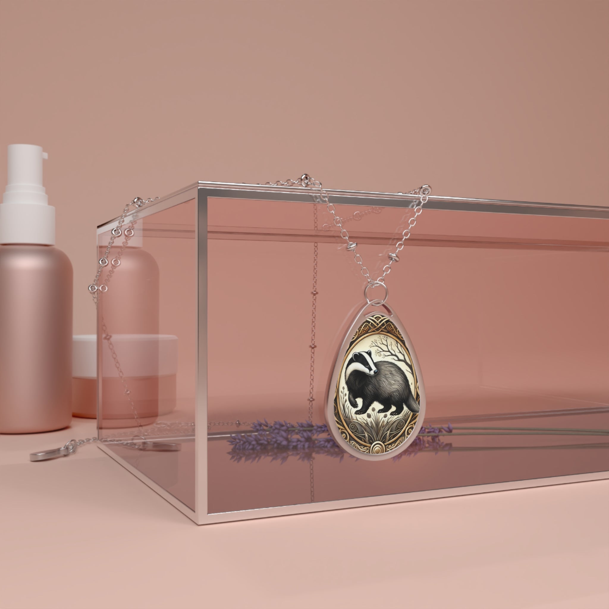 A beaver-themed teardrop-shaped pendant necklace is elegantly draped over a glass display case with a soft pink background. The pendant features a detailed illustration of a beaver surrounded by intricate golden patterns, capturing its industrious nature.