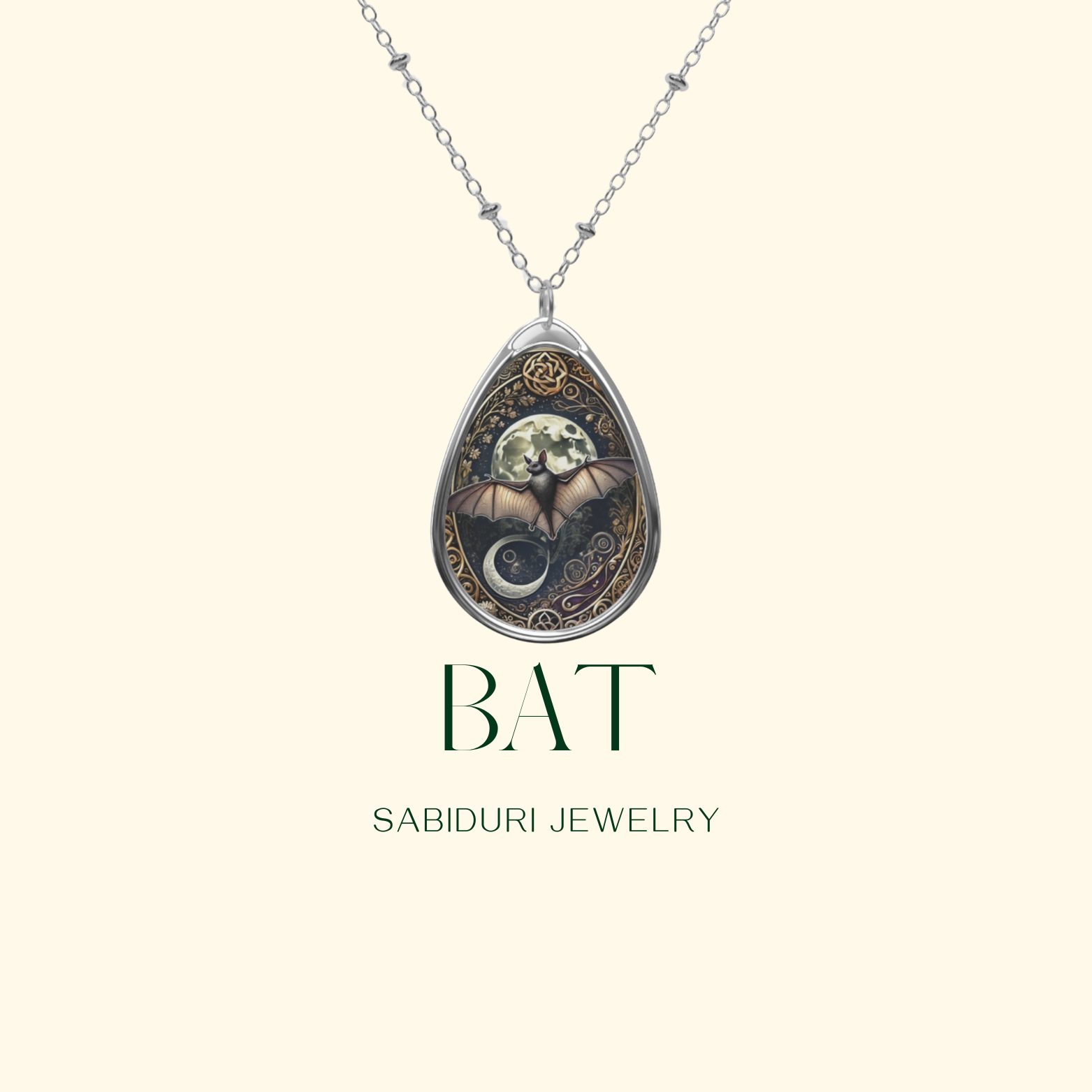 A close-up of a silver bat pendant necklace on a minimalist cream-colored background. The pendant features a bat with outstretched wings against a full moon, encircled by decorative elements and symbols. The text reads "BAT Sabiduri Jewelry.