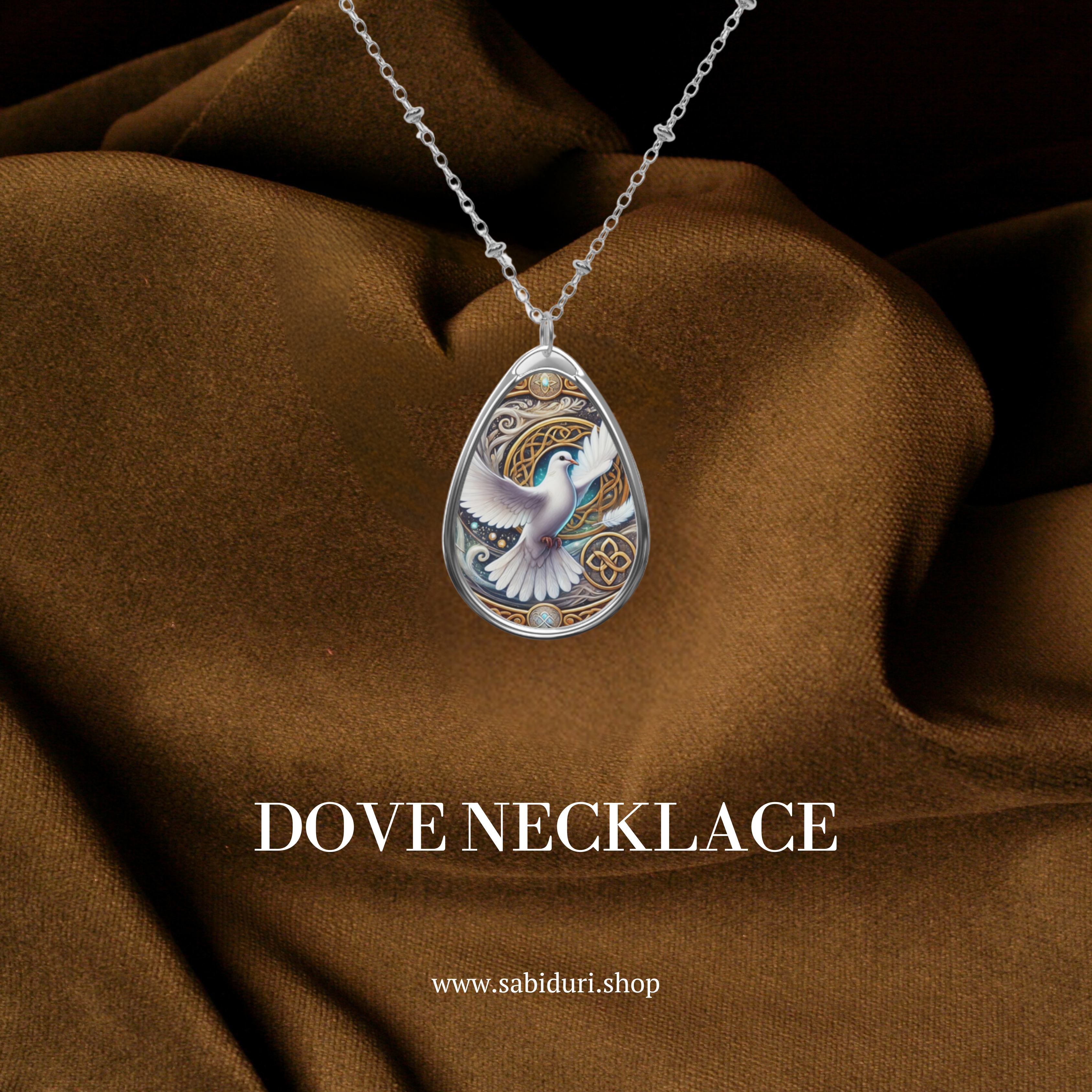 A close-up of the Dove spirit animal necklace, elegantly placed on a rich brown fabric. The pendant showcases a soaring white dove, golden swirls, and spiritual elements. Below, the text "DOVE NECKLACE" and "www.sabiduri.shop" are displayed in a refined serif font.