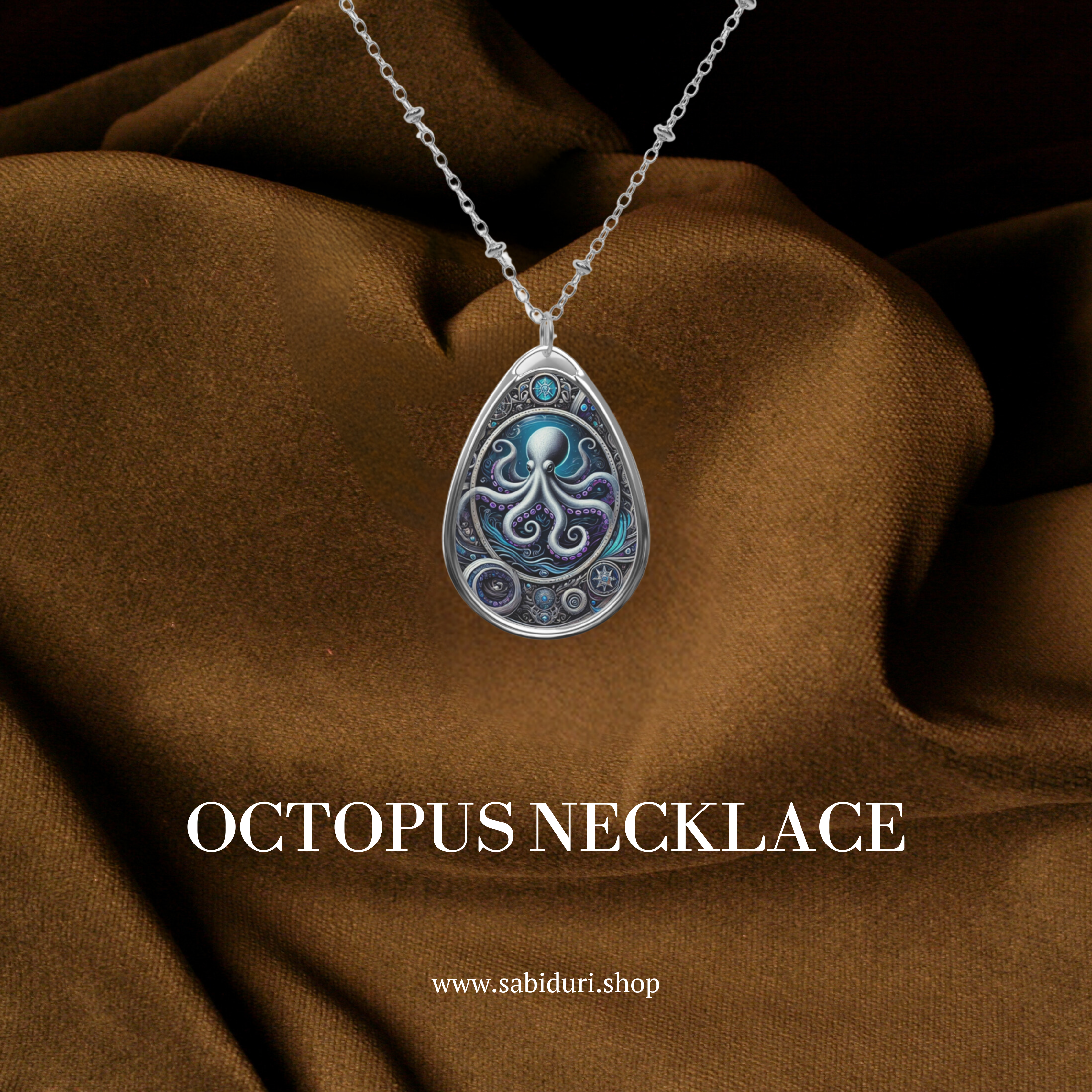 A silver necklace featuring a teardrop-shaped pendant with an intricate design of an octopus in deep blue and purple hues. The pendant is framed with metallic patterns and small circular embellishments. The necklace is displayed against a rich brown fabric background, with "OCTOPUS NECKLACE" and the website "www.sabiduri.shop" in white text.