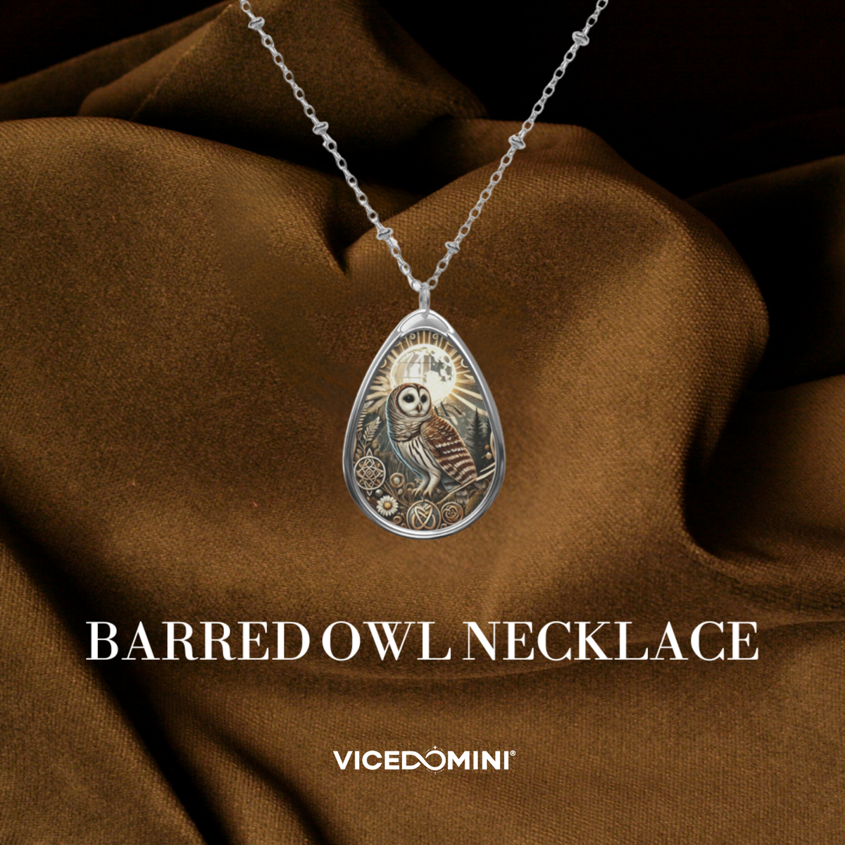 A silver-toned necklace with a teardrop pendant featuring an engraved owl design, draped over brown satin fabric. The text 'BARRED OWL NECKLACE' and the brand 'VICEDOMINI' are displayed below.