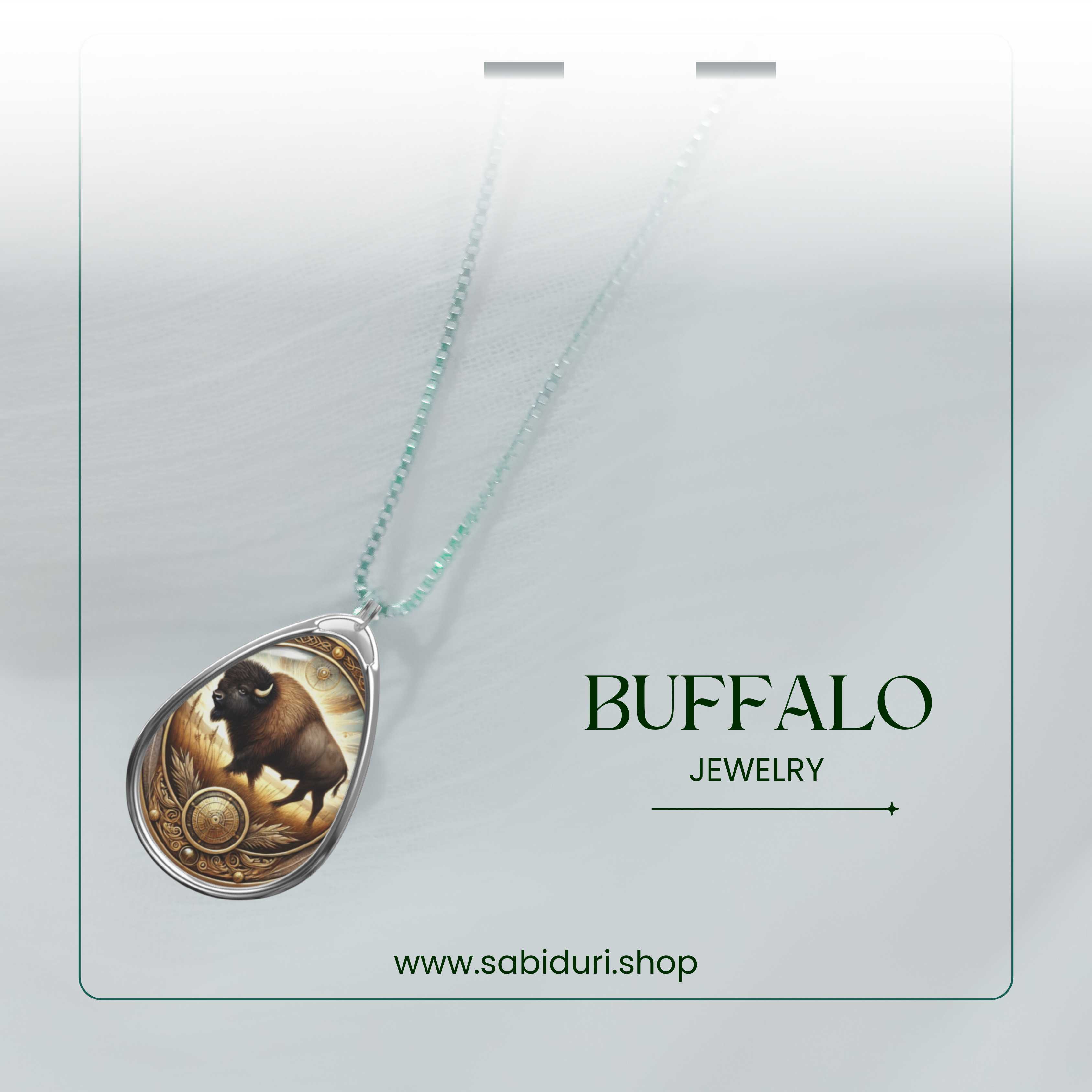 A buffalo pendant necklace with a celestial-inspired golden and brown design, placed on a translucent white fabric. The chain appears delicate, adding an ethereal quality to the image.