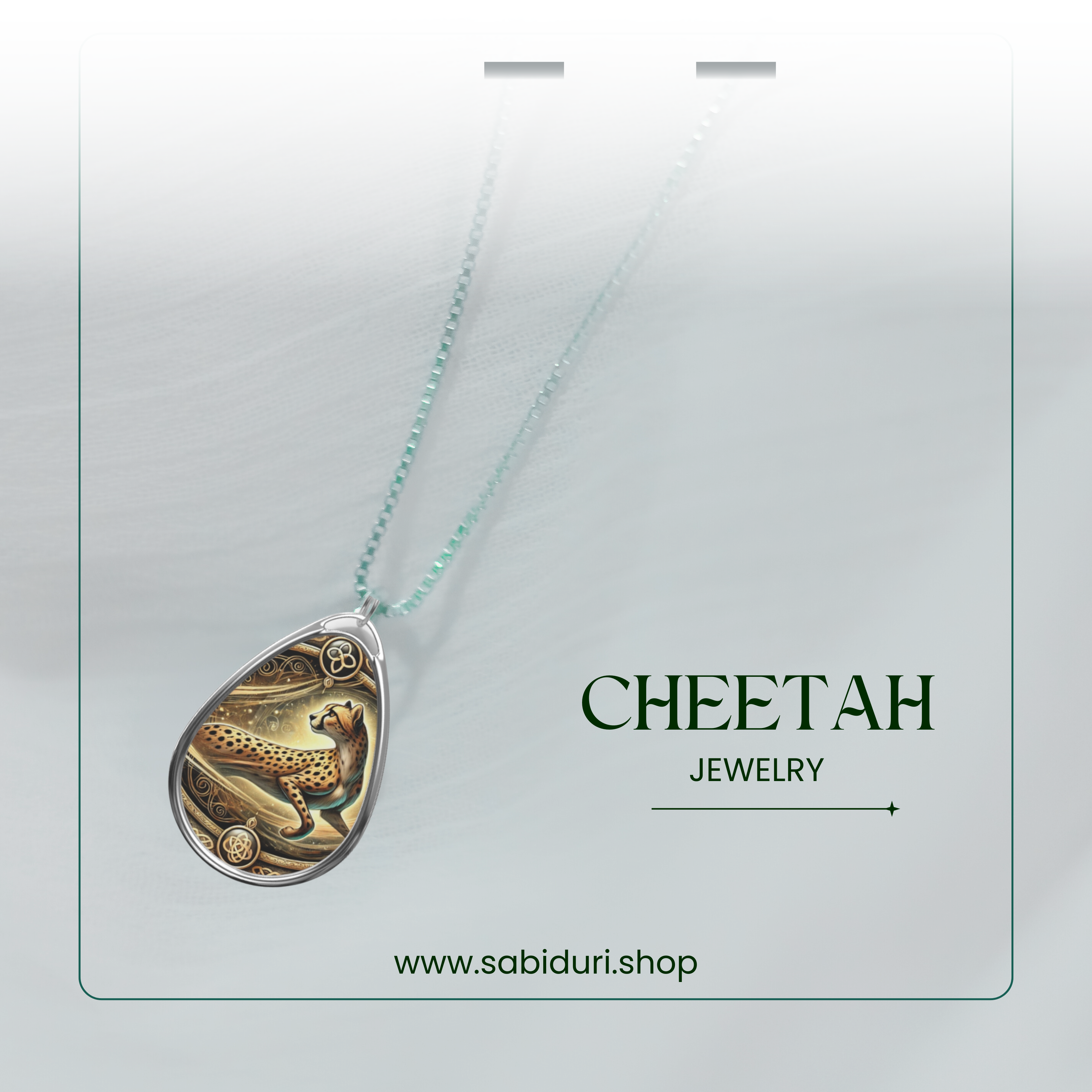 A stunning cheetah pendant necklace with ornate golden swirls, elegantly suspended from a delicate silver chain. The necklace is set against a soft, ethereal white backdrop, creating a dreamy and high-end jewelry aesthetic. Below, "Cheetah Jewelry" and "www.sabiduri.shop" add a branding touch.