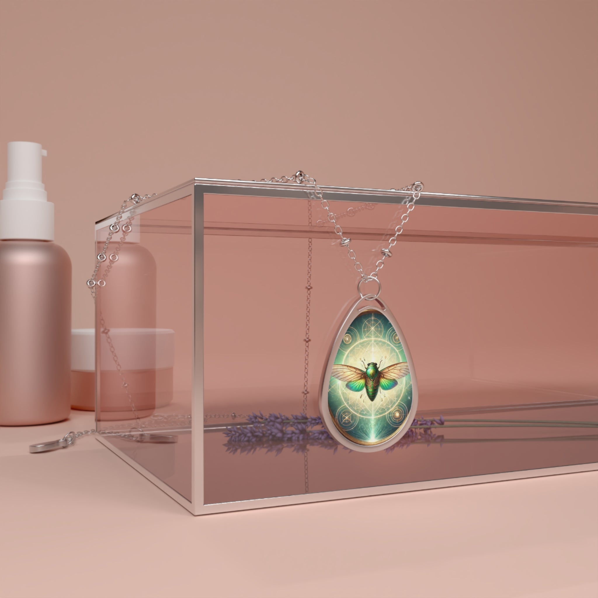 A silver teardrop-shaped necklace displayed on a pink glass box, featuring an intricate green cicada design with radiant light and celestial patterns in the background.