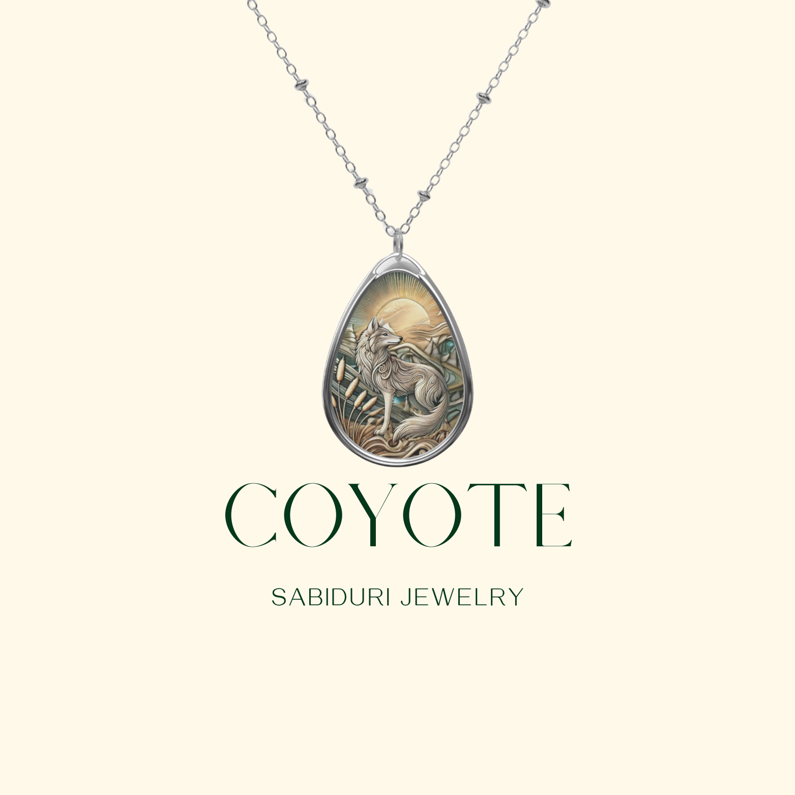 A coyote-themed necklace is displayed on a light background, featuring a detailed teardrop-shaped pendant with a coyote and sunrise design. The text "COYOTE" and "SABIDURI JEWELRY" is shown below the pendant, emphasizing the brand and design.