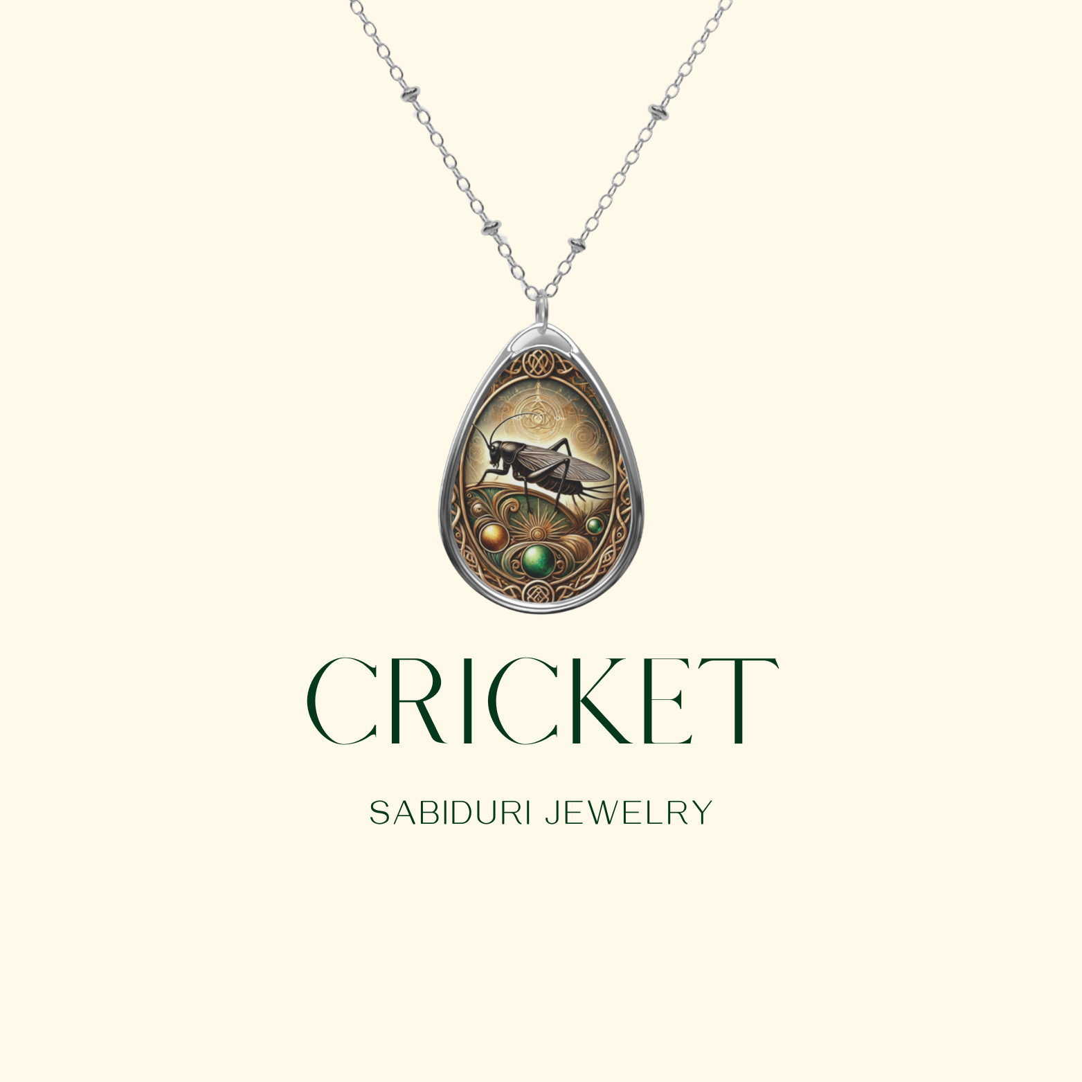 A teardrop pendant necklace with a beautifully detailed cricket illustration is showcased against a clean, cream-colored background. The words "CRICKET" and "SABIDURI JEWELRY" are printed in an elegant green font, emphasizing the necklace's natural and earthy aesthetic.