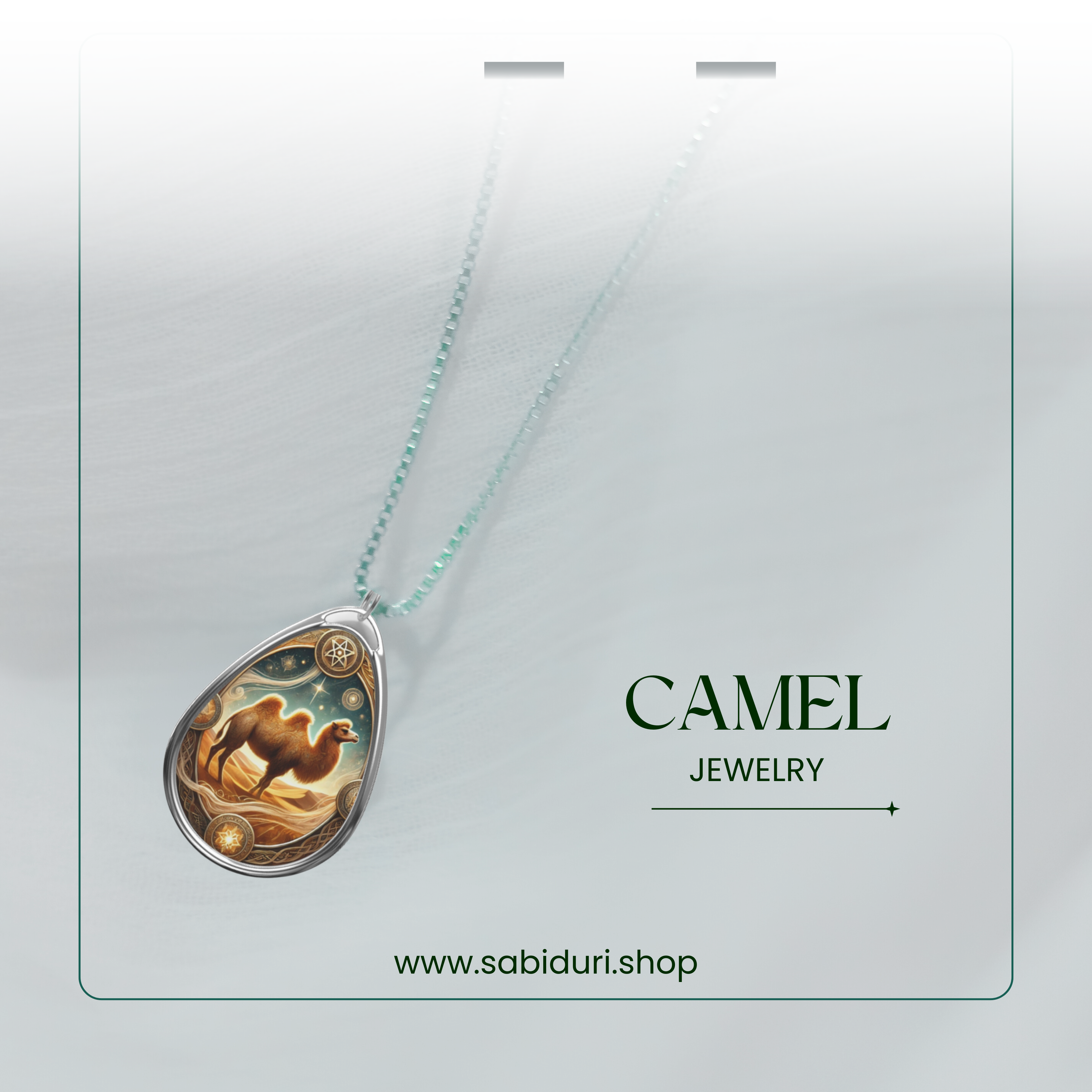A Camel spirit pendant necklace elegantly displayed on a soft white background with a thin green frame. The pendant’s artwork captures a camel under a golden desert sky, decorated with celestial motifs. The text "CAMEL JEWELRY" and "www.sabiduri.shop" appear at the bottom.