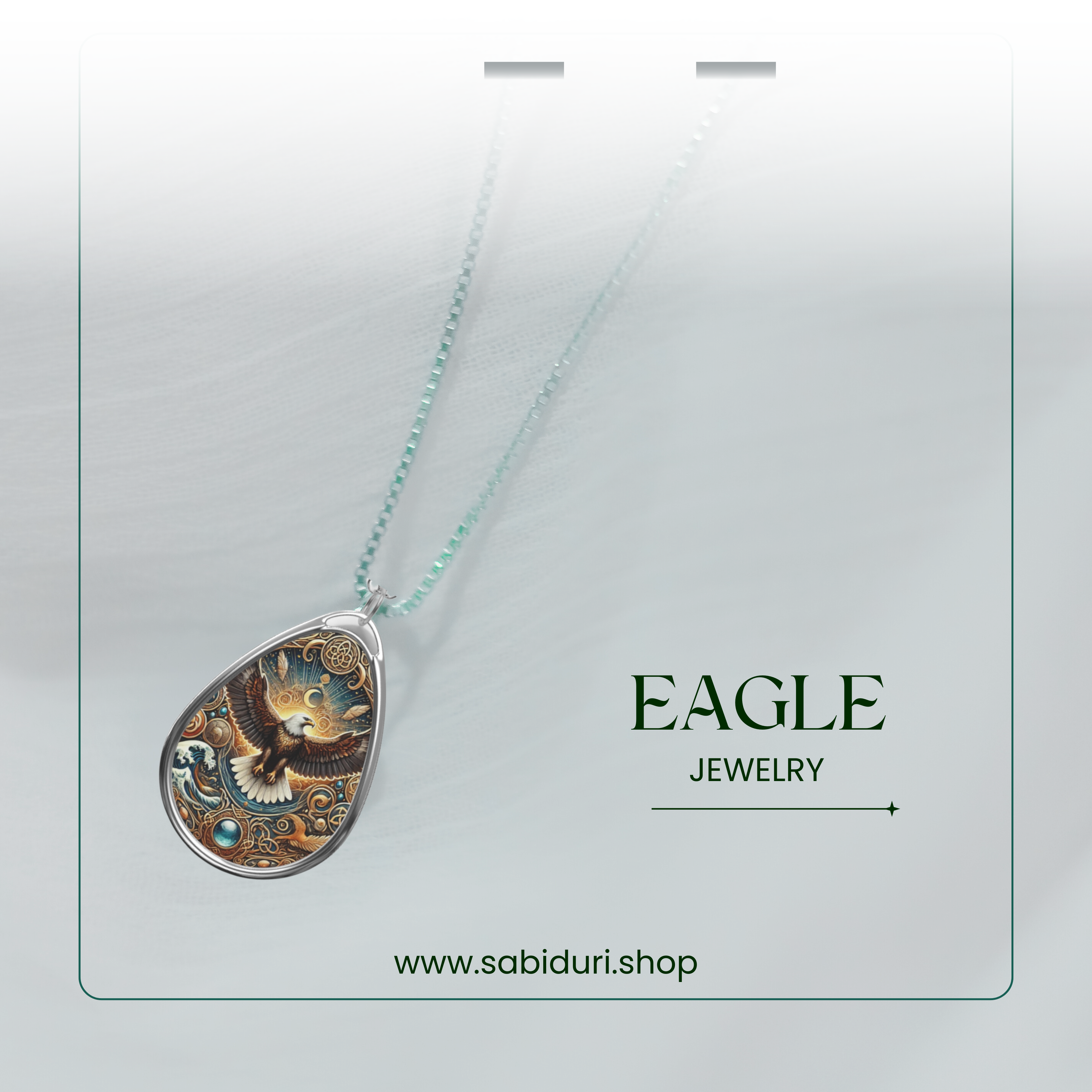 The eagle necklace is gracefully draped on a white surface, with a blurred background giving a dreamy, ethereal feel. A delicate greenish-blue beaded chain complements the pendant’s intricate celestial design. The text overlay reads "EAGLE JEWELRY" with a link to "www.sabiduri.shop."