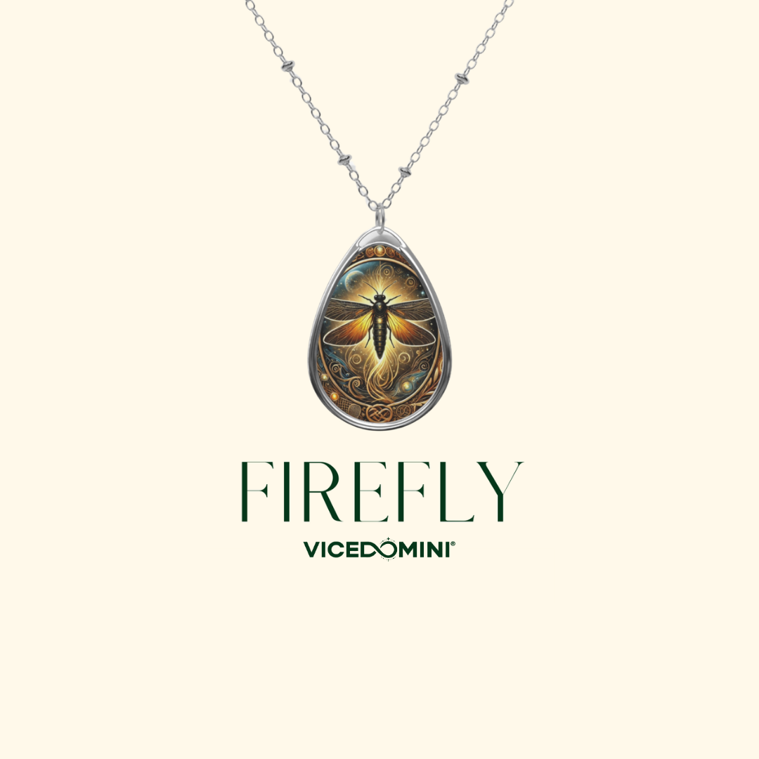 A teardrop-shaped pendant necklace featuring a detailed firefly illustration with a silver-toned chain, displayed on a light cream background with the brand name 'VICEDOMINI' and product name 'FIREFLY' printed below.
