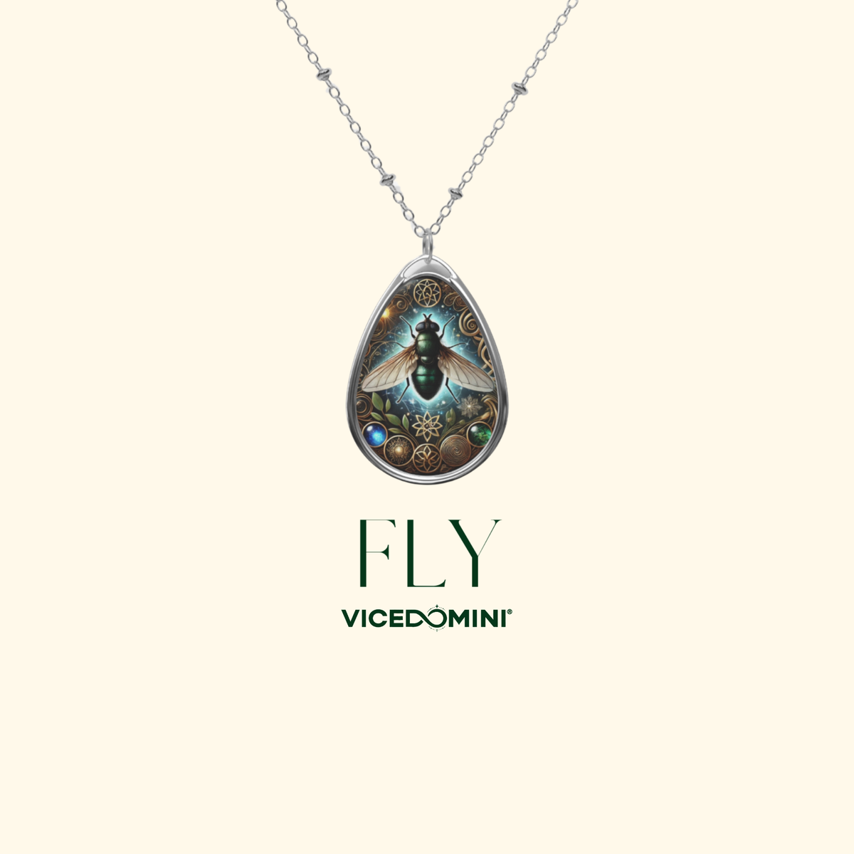 A silver teardrop pendant necklace featuring a detailed illustration of a flying insect surrounded by small gold and blue elements, shown on a light cream background with the text 'FLY VICEDOMINI' below.