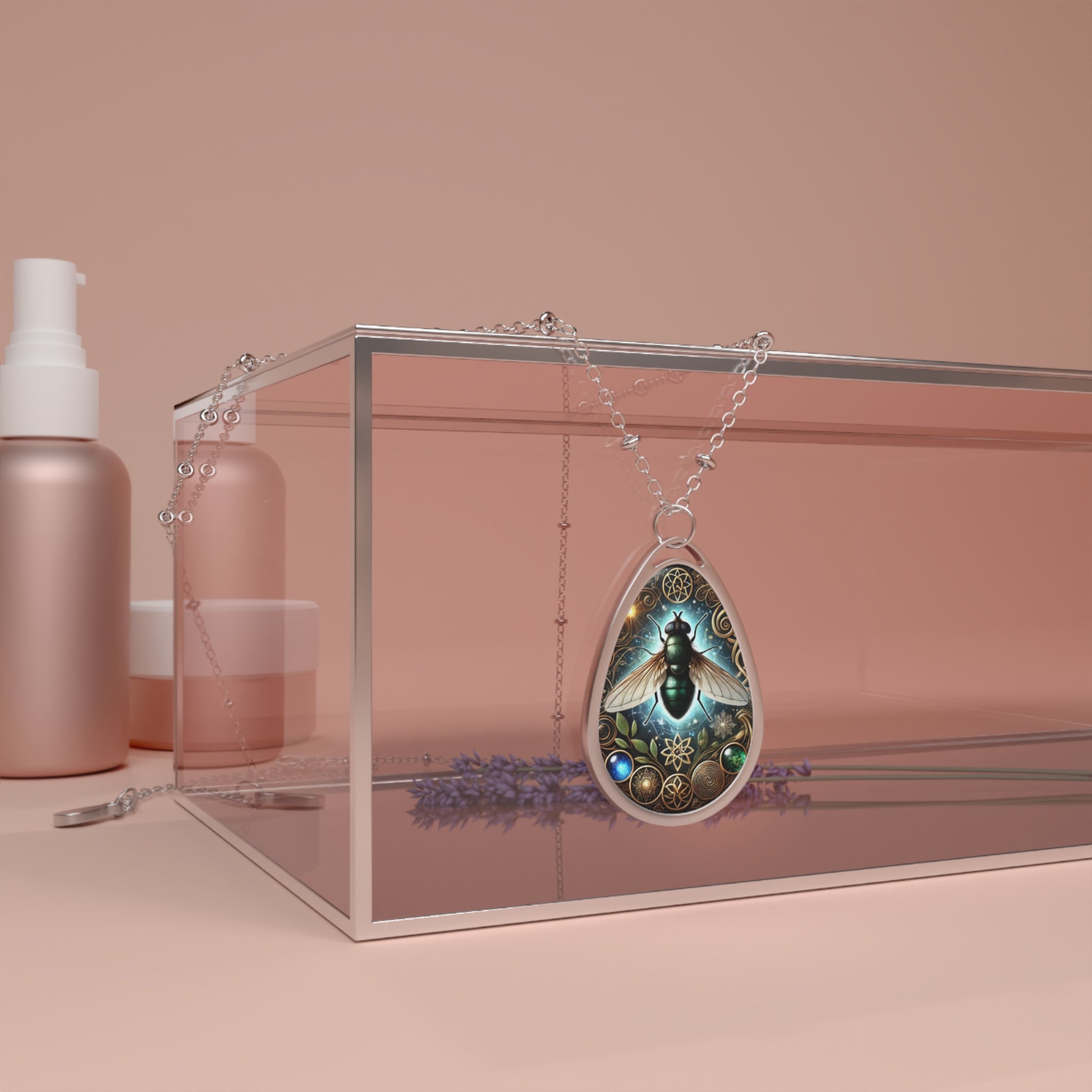 A lifestyle shot of the Fly Spirit Animal necklace draped over a transparent jewelry box with soft pink reflections. The pendant’s mystical fly design glows against the warm background, with a delicate silver chain resting around the box. A sprig of lavender adds a touch of nature to the composition.