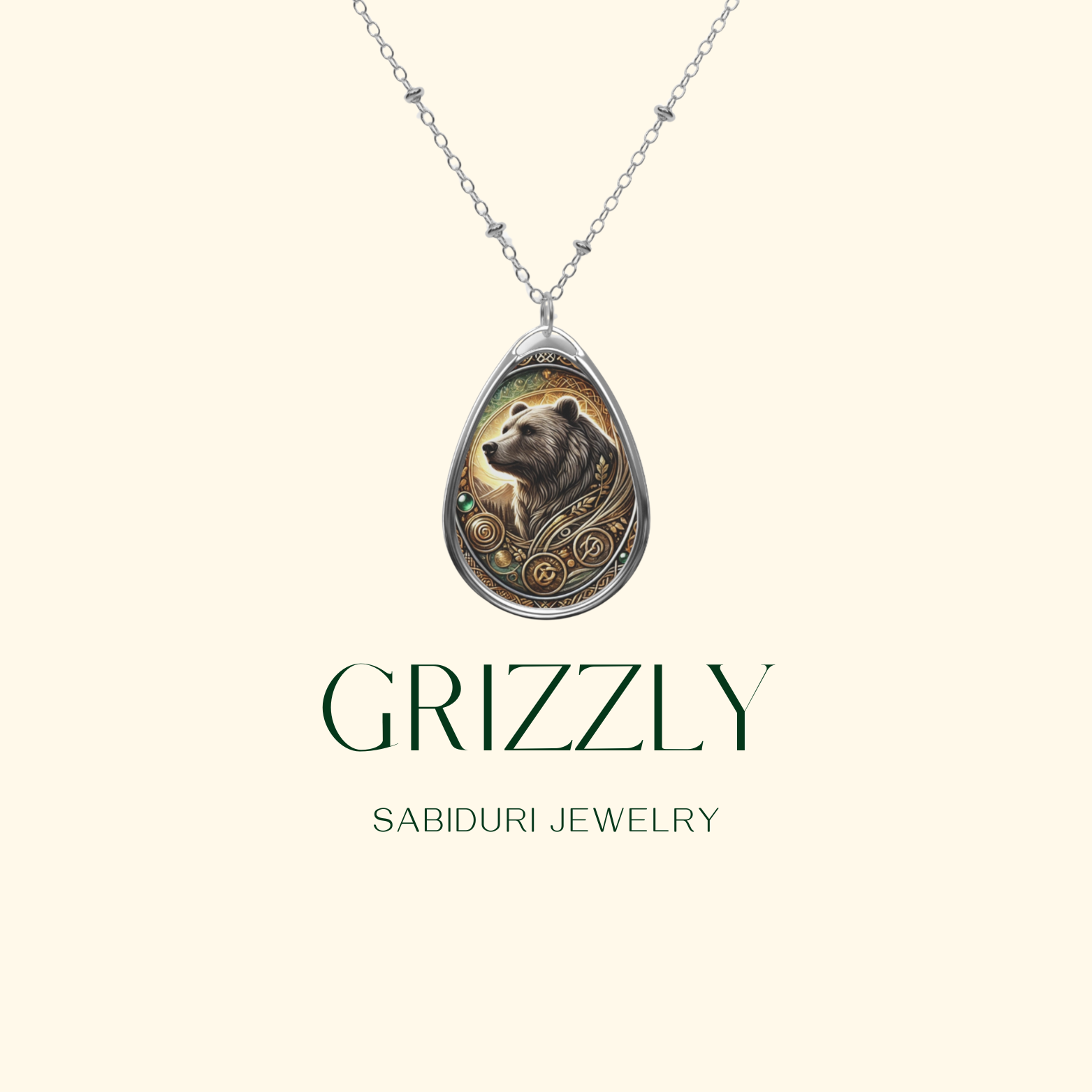 A minimalist advertisement featuring the grizzly bear pendant on a light beige background. The word "GRIZZLY" appears in bold green letters, followed by "SABIDURI JEWELRY" in smaller text, emphasizing the brand.