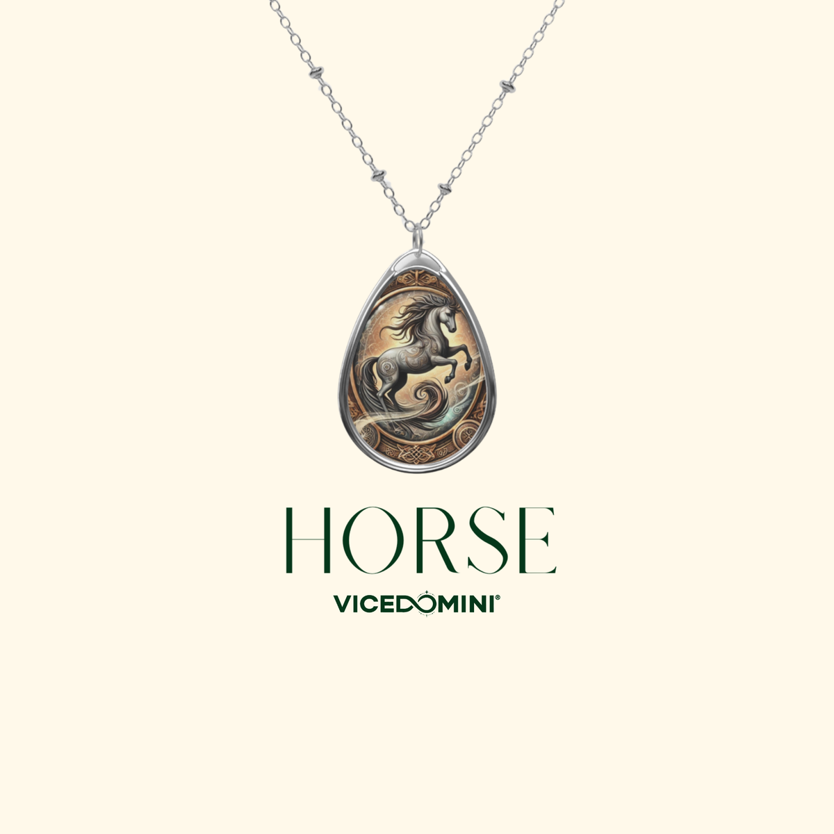A silver teardrop pendant necklace featuring an engraved horse design, displayed on a light cream background with the text 'HORSE Vicedomini' underneath.