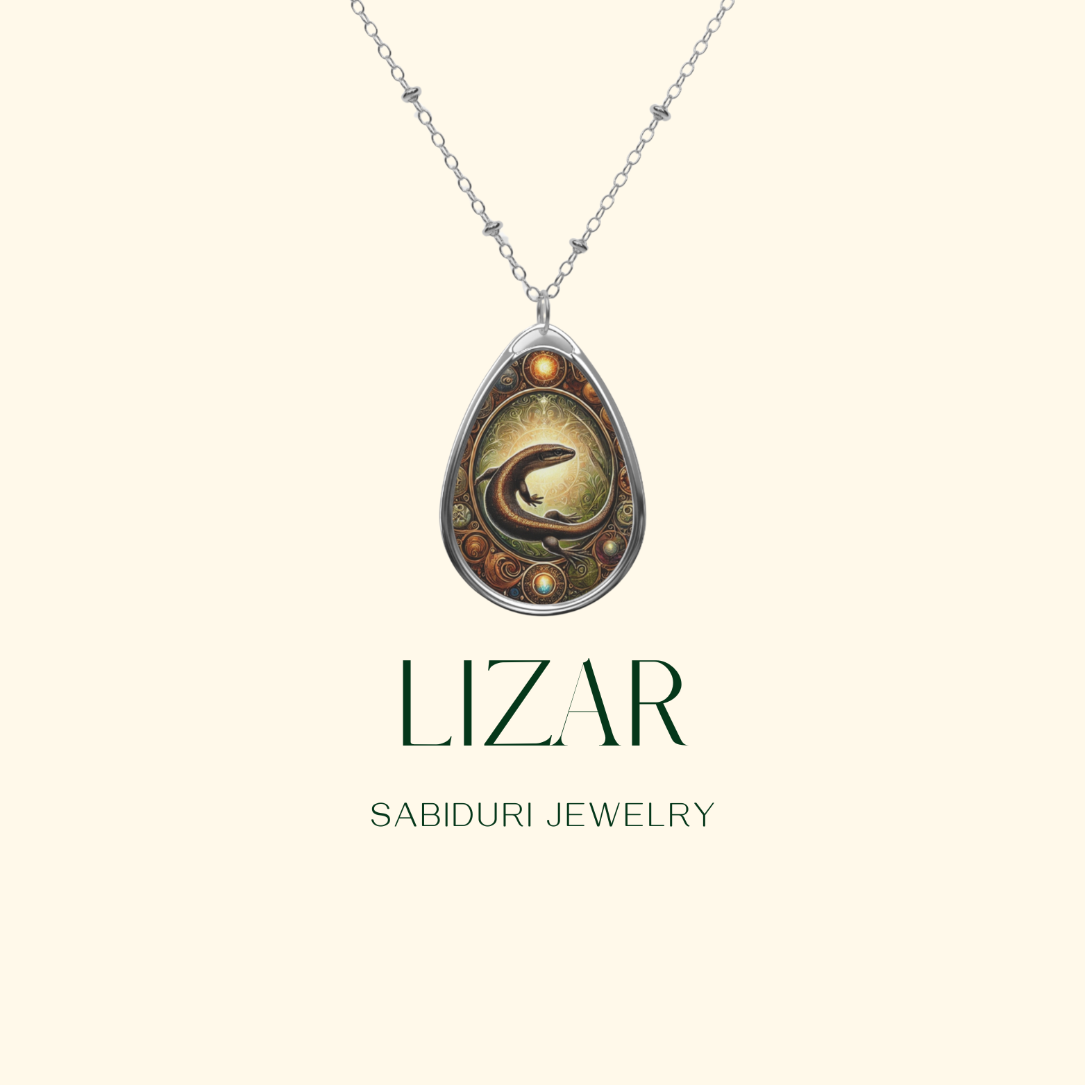 A close-up of the Lizard spirit animal pendant necklace against a cream background. The silver-framed pendant showcases a finely crafted lizard with golden and amber hues, detailed swirls, and ornate gemstone-like accents. The words "LIZARD" and "SABIDURI JEWELRY" are elegantly written below.