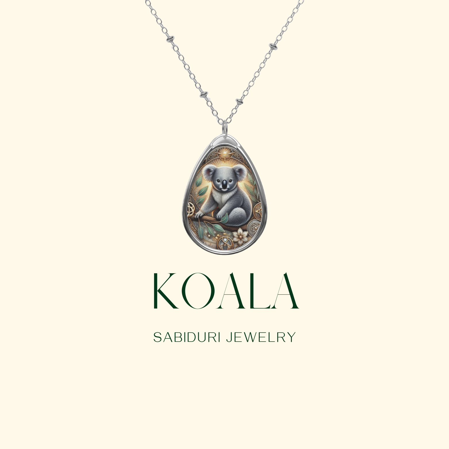 A close-up of the Koala Spirit Animal Necklace against a minimalist cream background. The pendant showcases a serene koala sitting among leaves and golden celestial details. The text "KOALA" and "SABIDURI JEWELRY" is displayed below.