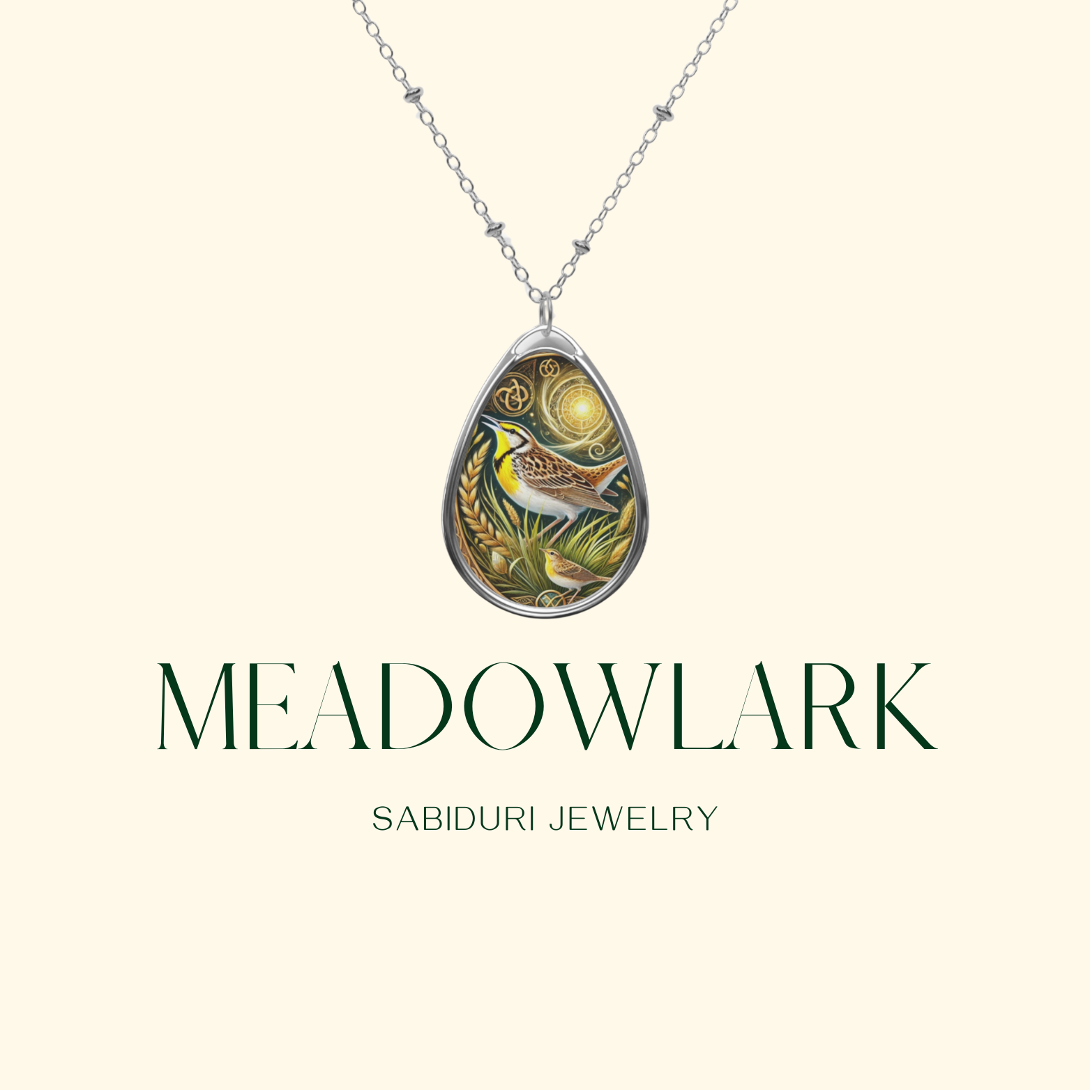 A teardrop-shaped pendant necklace featuring an intricately designed meadowlark bird, surrounded by golden wheat and a glowing celestial pattern. The detailed artwork combines earthy tones and metallic accents, giving the piece an elegant, nature-inspired aesthetic. Below the necklace, the text reads "MEADOWLARK" with "SABIDURI JEWELRY" in smaller print.