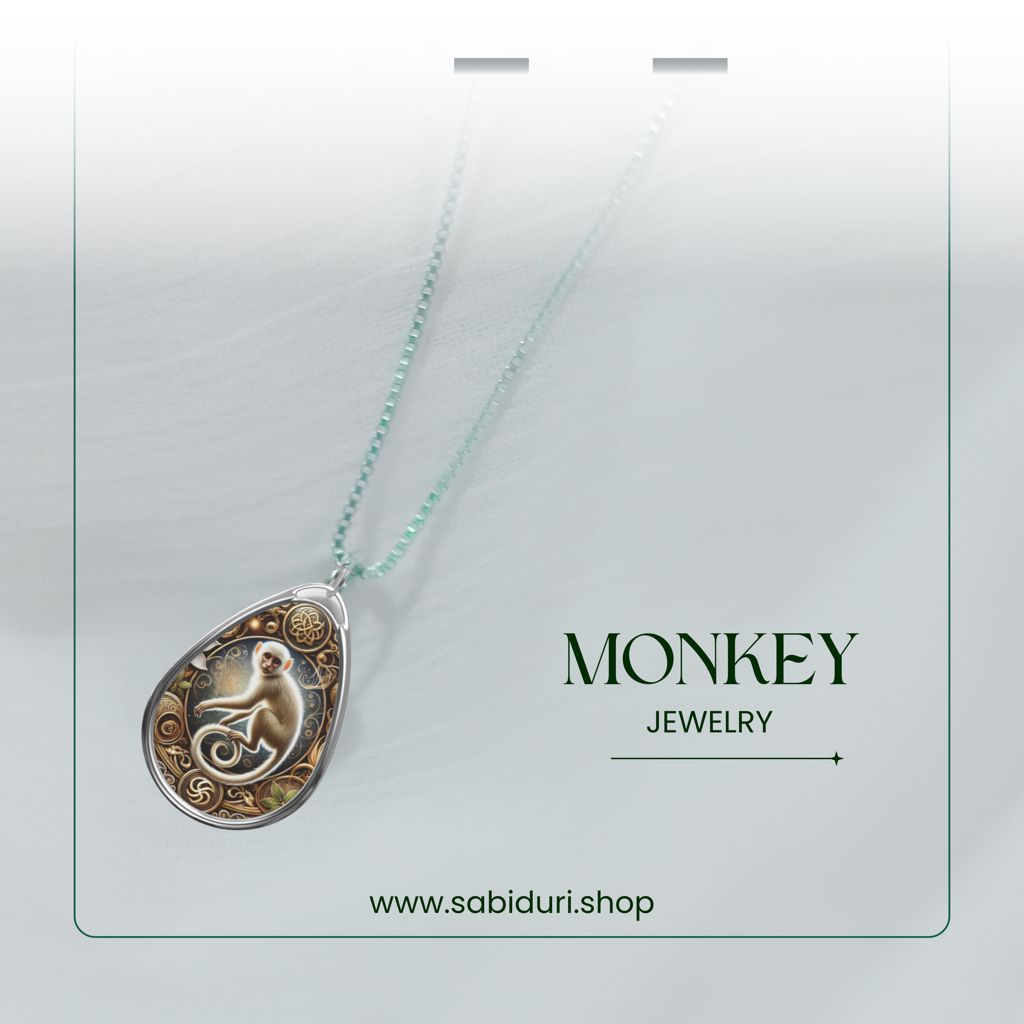 A close-up of a monkey-themed pendant hanging from a delicate chain, displayed in a clean, modern presentation. The image has a light, airy background with "MONKEY JEWELRY" and "www.sabiduri.shop" written below.