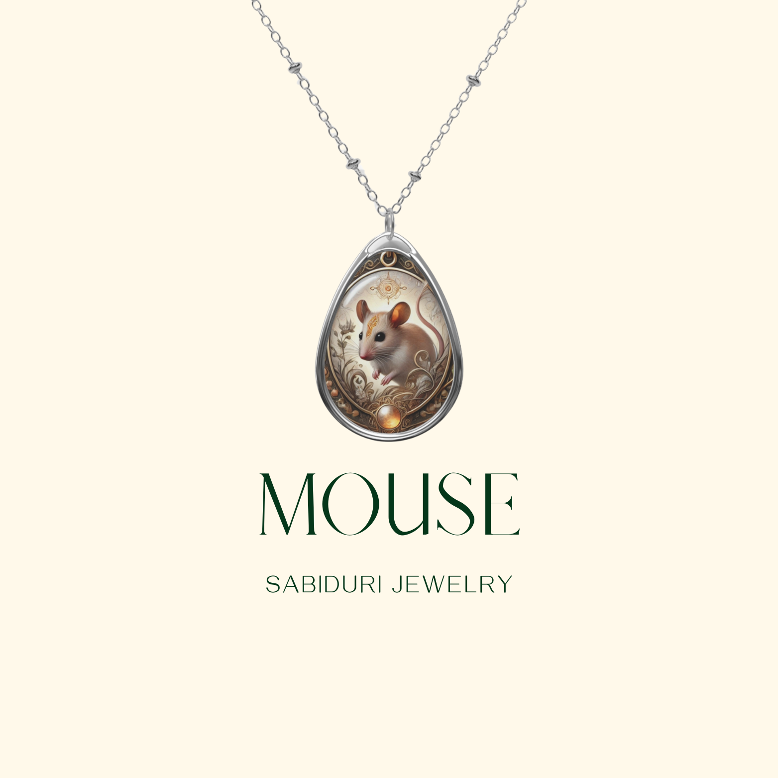 A close-up of a teardrop-shaped pendant necklace with an elegant mouse illustration surrounded by golden filigree and nature-inspired patterns. The pendant hangs from a silver chain against a minimalist cream-colored background with "MOUSE - SABIDURI JEWELRY" written below.