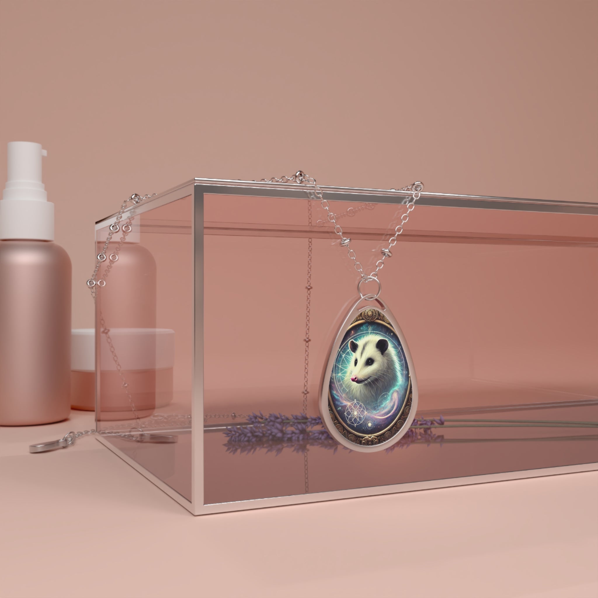 A stunning opossum pendant necklace draped over a sleek, transparent glass box. The pendant features a beautifully detailed opossum surrounded by swirling celestial energy and an ornate golden border. Soft pink cosmetic containers and a sprig of lavender are in the background, adding a luxurious and serene touch.